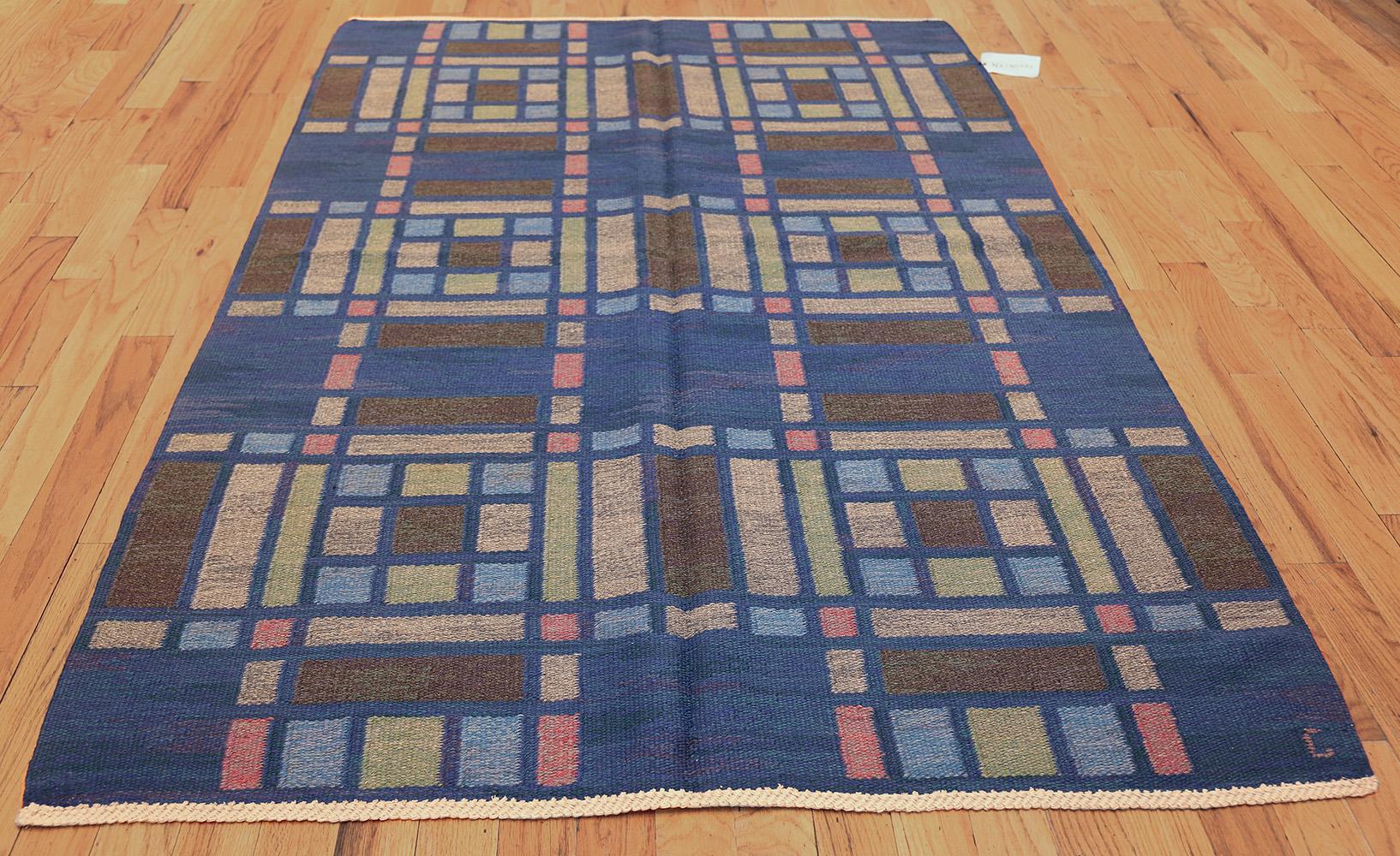Vintage Swedish rug by Judith Johansson, Origin: Sweden, circa midcentury. Size: 5 ft x 7 ft 7 in (1.52 m x 2.31 m)

This splendid vintage rug from Scandinavia by weaver Judith Johansson features a striking compartmental composition with strong