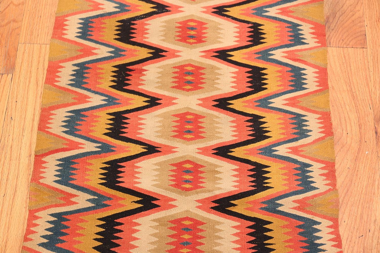 Vintage Swedish Kilim rug, country of origin: Scandinavia, date: circa mid-20th century. Size: 1 ft 8 in x 5 ft 6 in (0.51 m x 1.68 m). 

Crenellated octagons with radiant outlines create a bold repeating pattern rendered in a graphic selection of