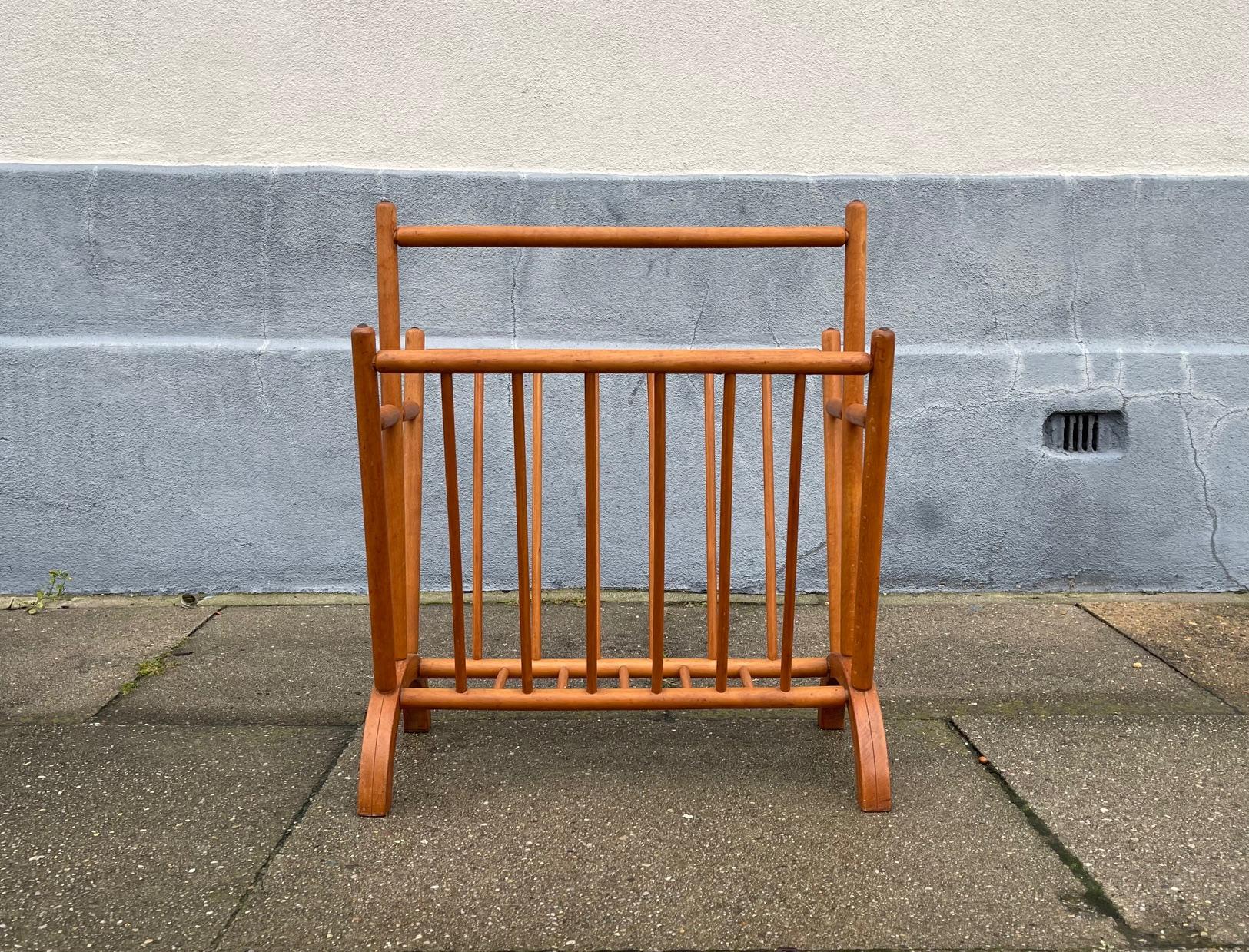 A stylish magazine stand in solid beech with teak accents. Its assembled without the use of metal. Round-stick tecnique with bend-wood 'legs'. Anonymously made in Sweden during the 1960s in a style reminiscent of Hans Jorgen Wegner and Borge