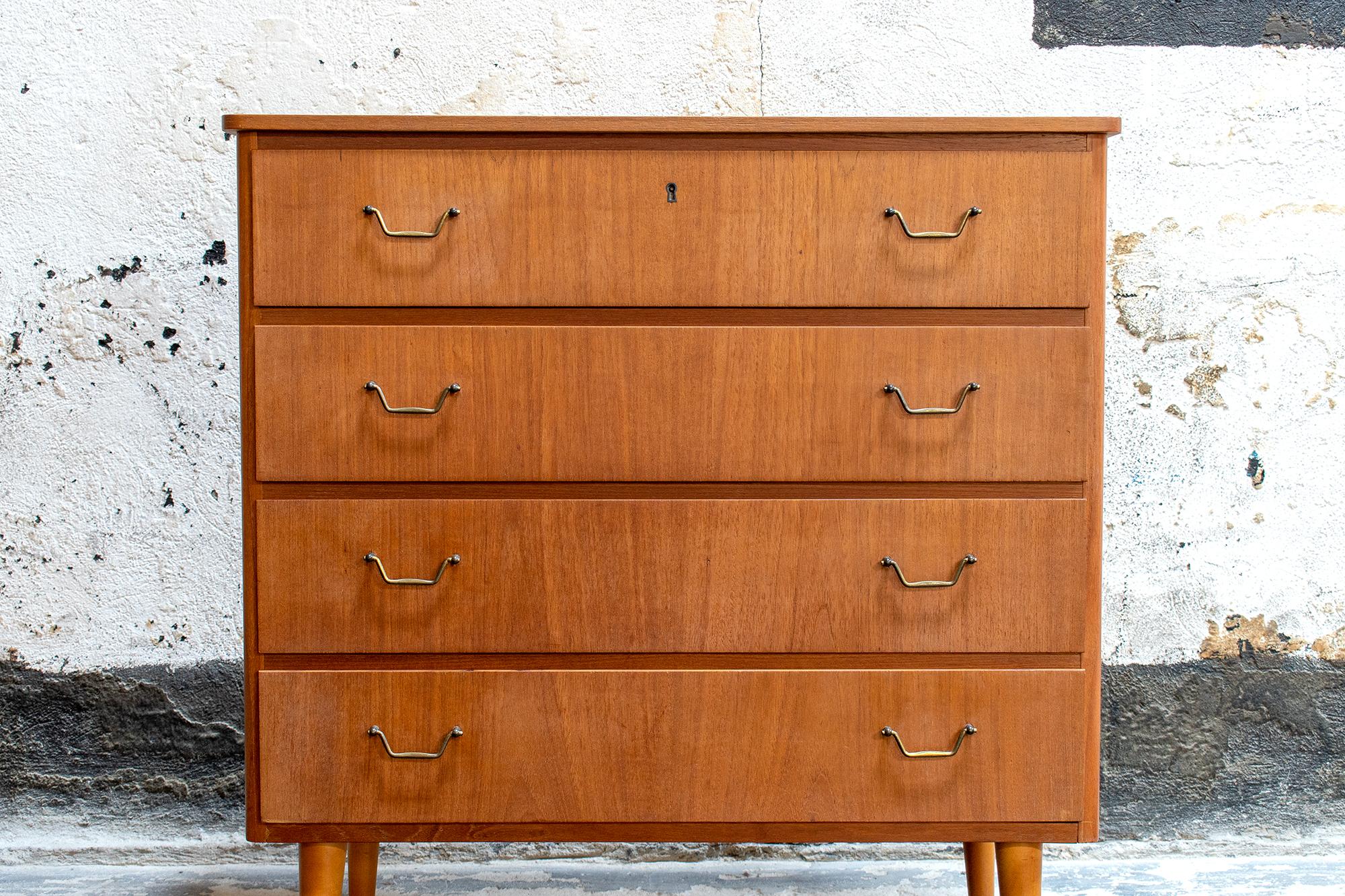 Handsome vintage chest of drawers from 1950s, Sweden. Crafted of rich teak, this piece features four ample - and easily workable - drawers with original hardware and sleek tapered legs. Perfect as a dresser, end table, nightstand or console. Very
