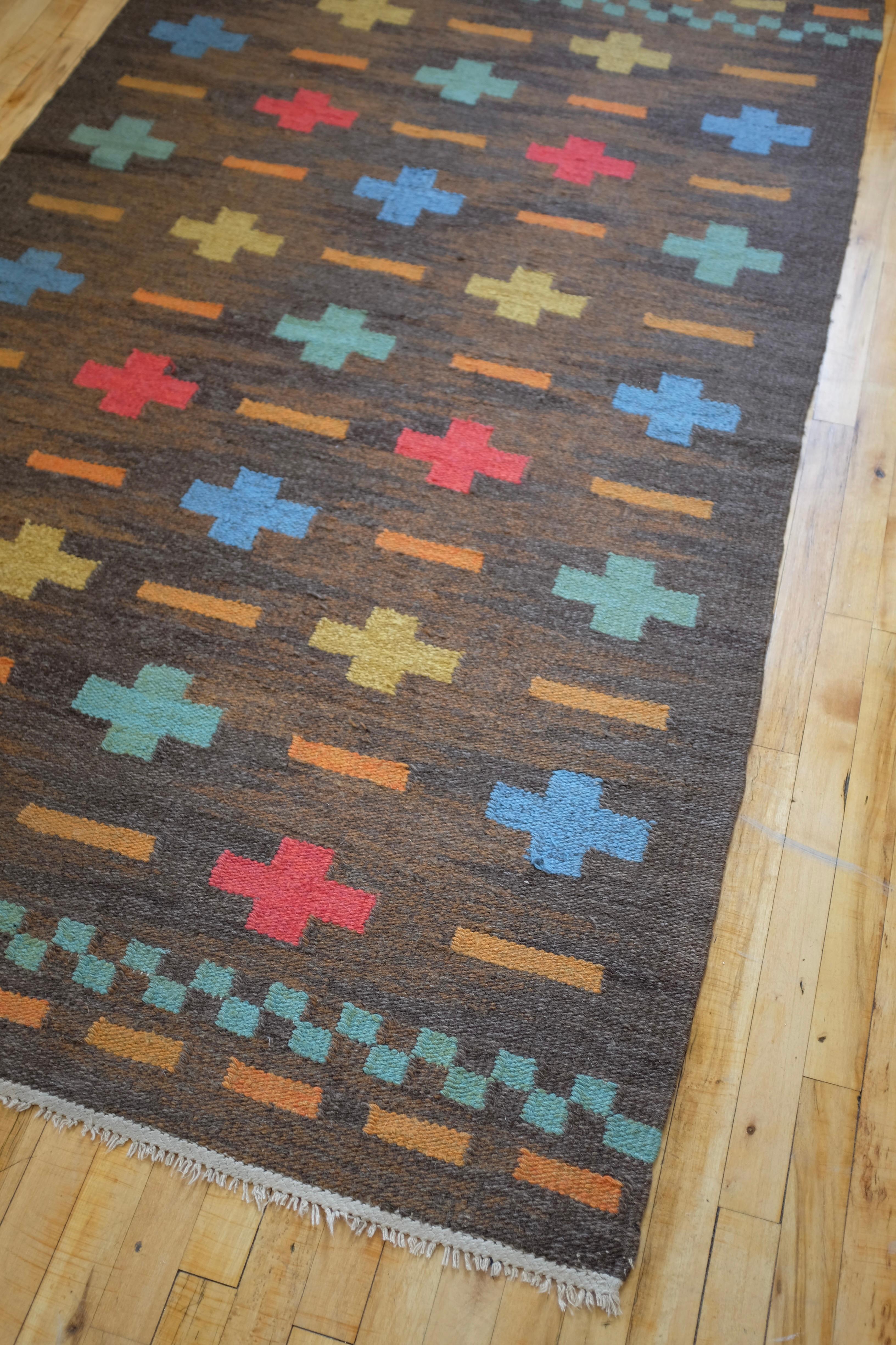 Vintage Swedish Mid-century rug with a brown background and cross pattern in red, blue and green. Unsigned and by unknown designer. Good vintage condition with visible signs of wear.

Rug Dimensions: 88 x 51.5 inches