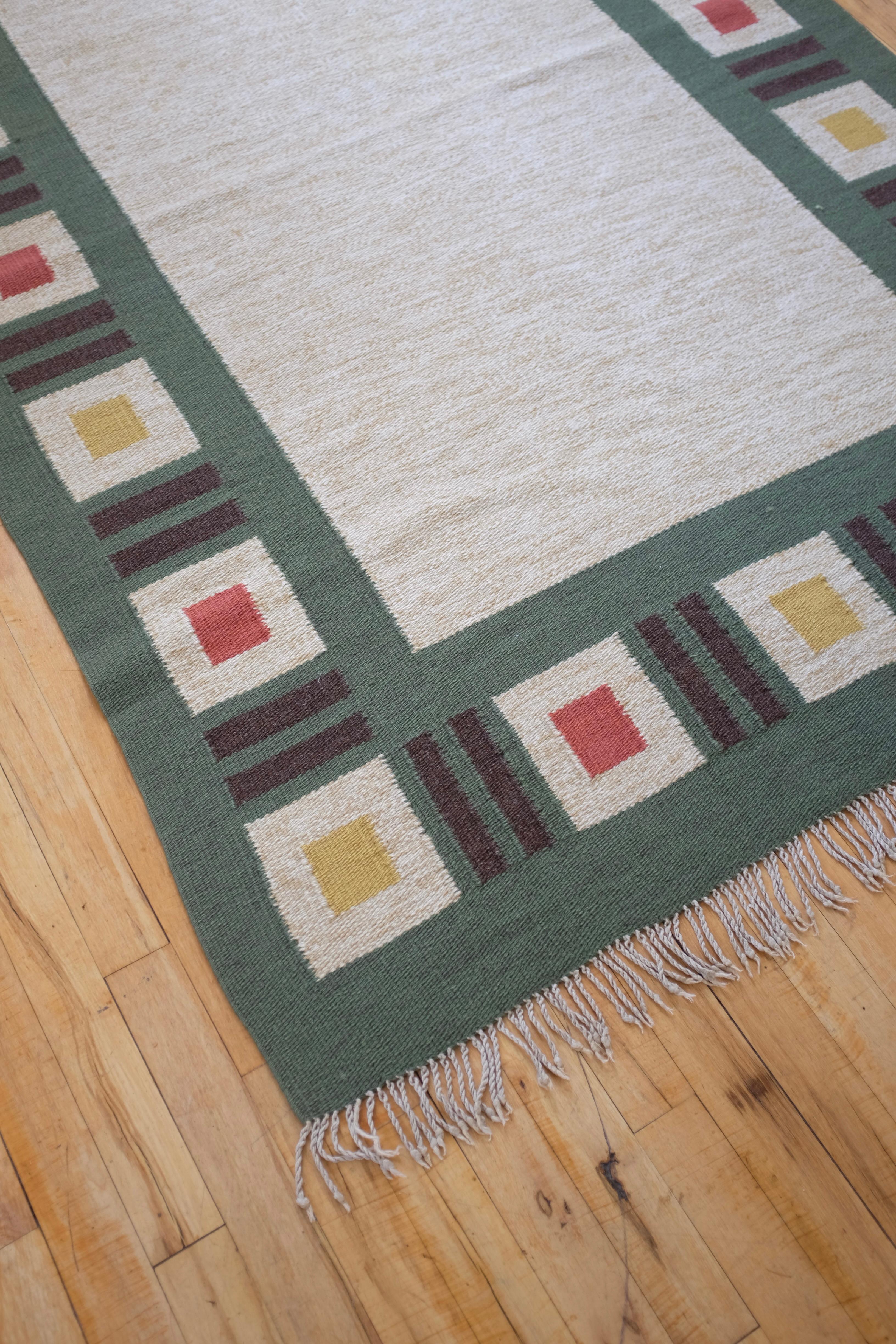 Vintage Swedish Mid-century rug with a green border with a squares in yellow, red and beige. Good vintage condition with visible signs of wear and uneven sides.

Rug Dimensions: 82 x 49 inches