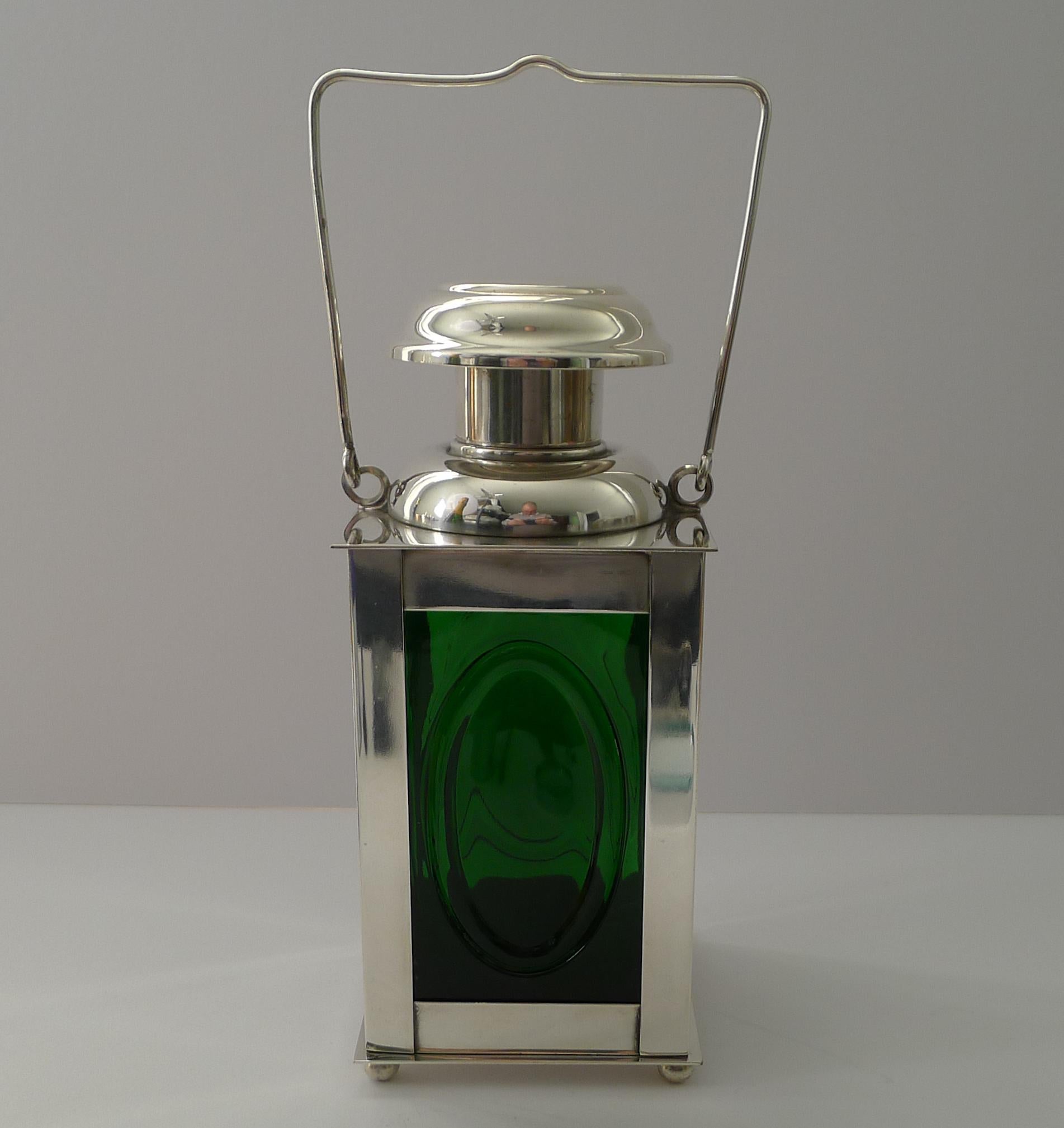 A wonderful and fun decanter or cocktail shaker made from silver plate with the original green bottle or decanter within in the form of a Marine or Railway Signal Lantern

The underside is where the full mark can be found, I believe for the