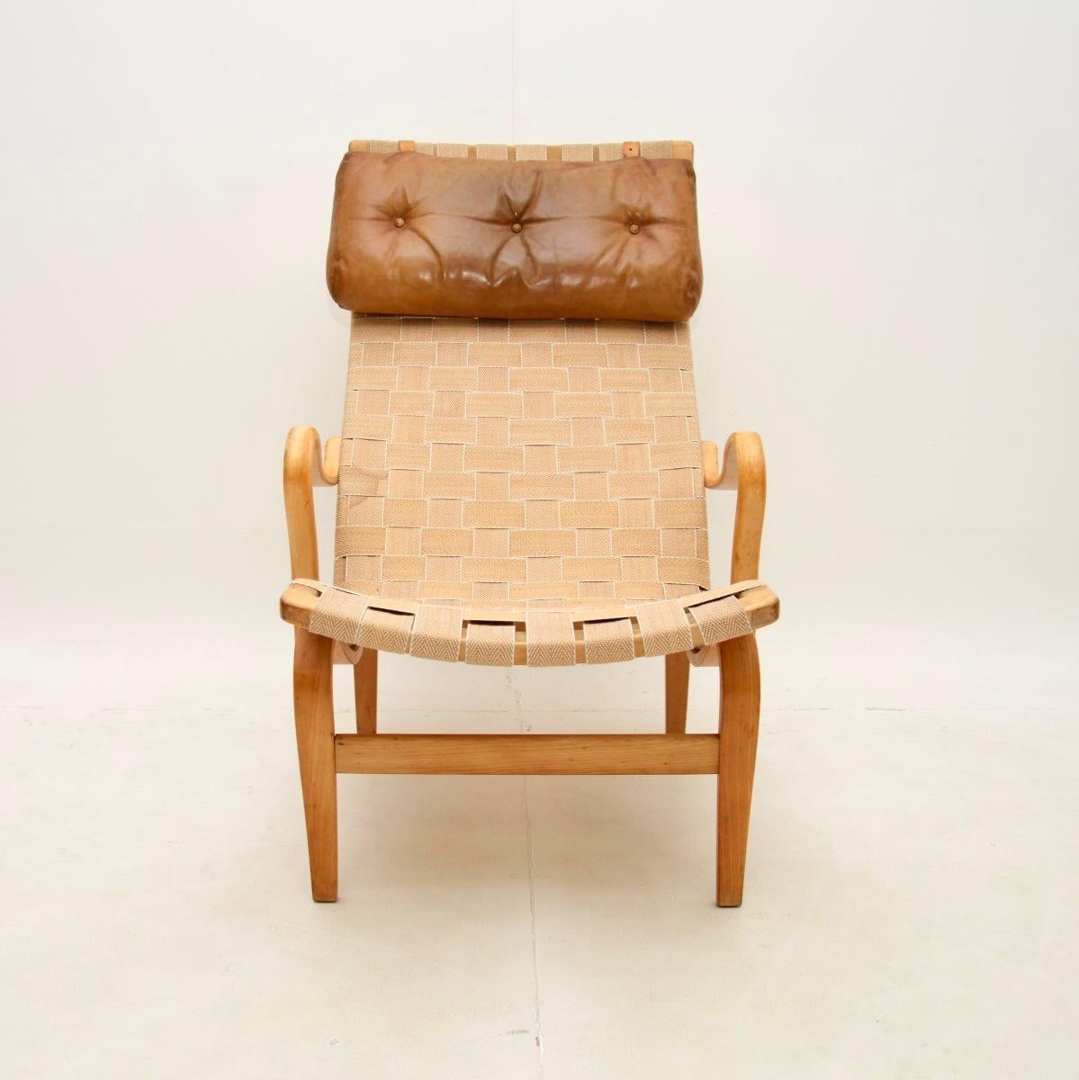 An iconic and extremely comfortable vintage Swedish Pernilla armchair by Bruno Mathsson for Dux. This was made in Sweden, it dates from the 1960’s.

This design is stylish and practical, it has sweeping curves and a high quality yet lightweight