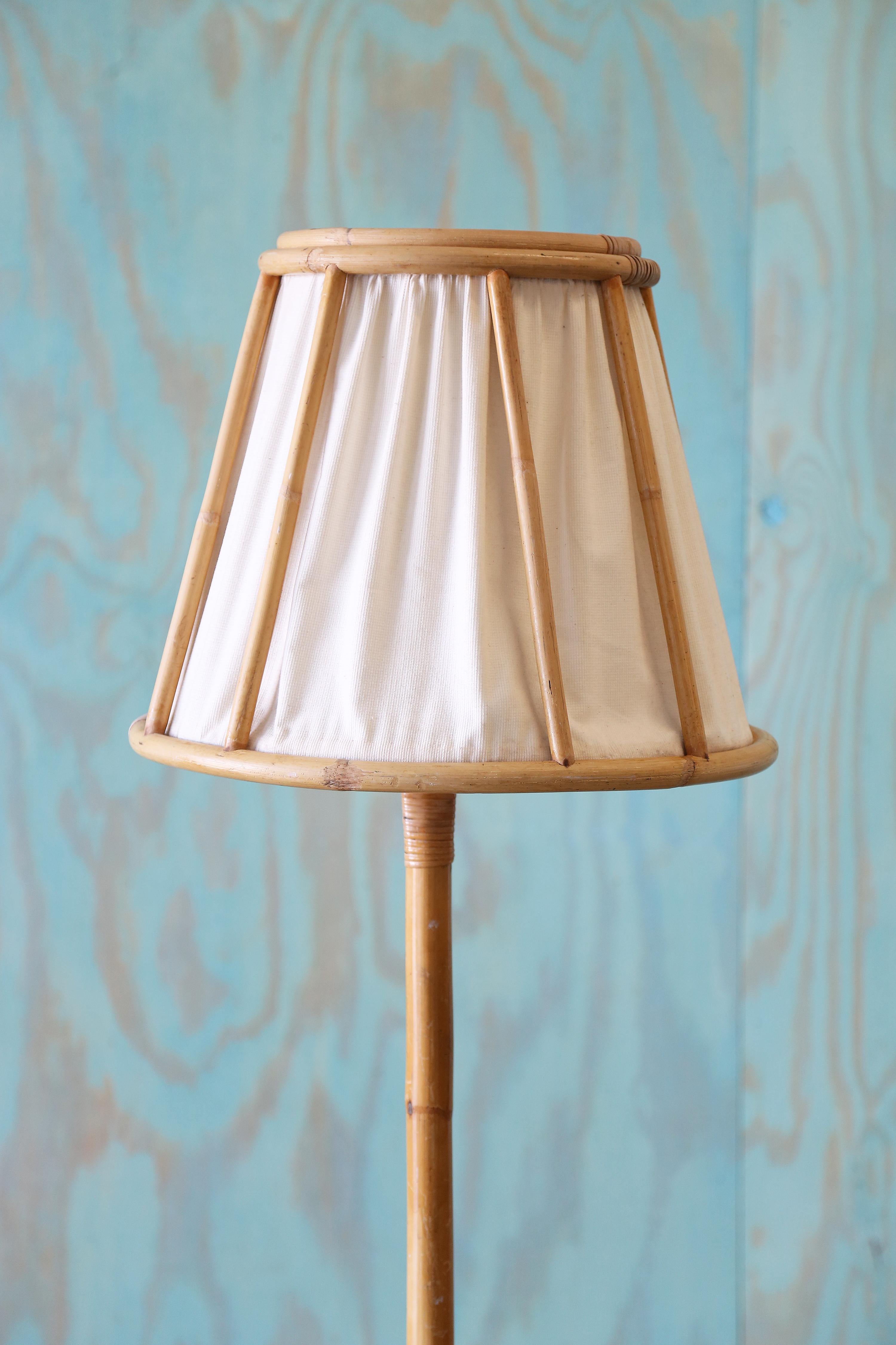 Lampadaire suédois vintage en rotin et canne avec un abat-jour en lin. De superbes vibrations côtières boho modernes. Design/One unique, on n'en voit pas tous les jours.

Non signée.

Dimensions : 62,5