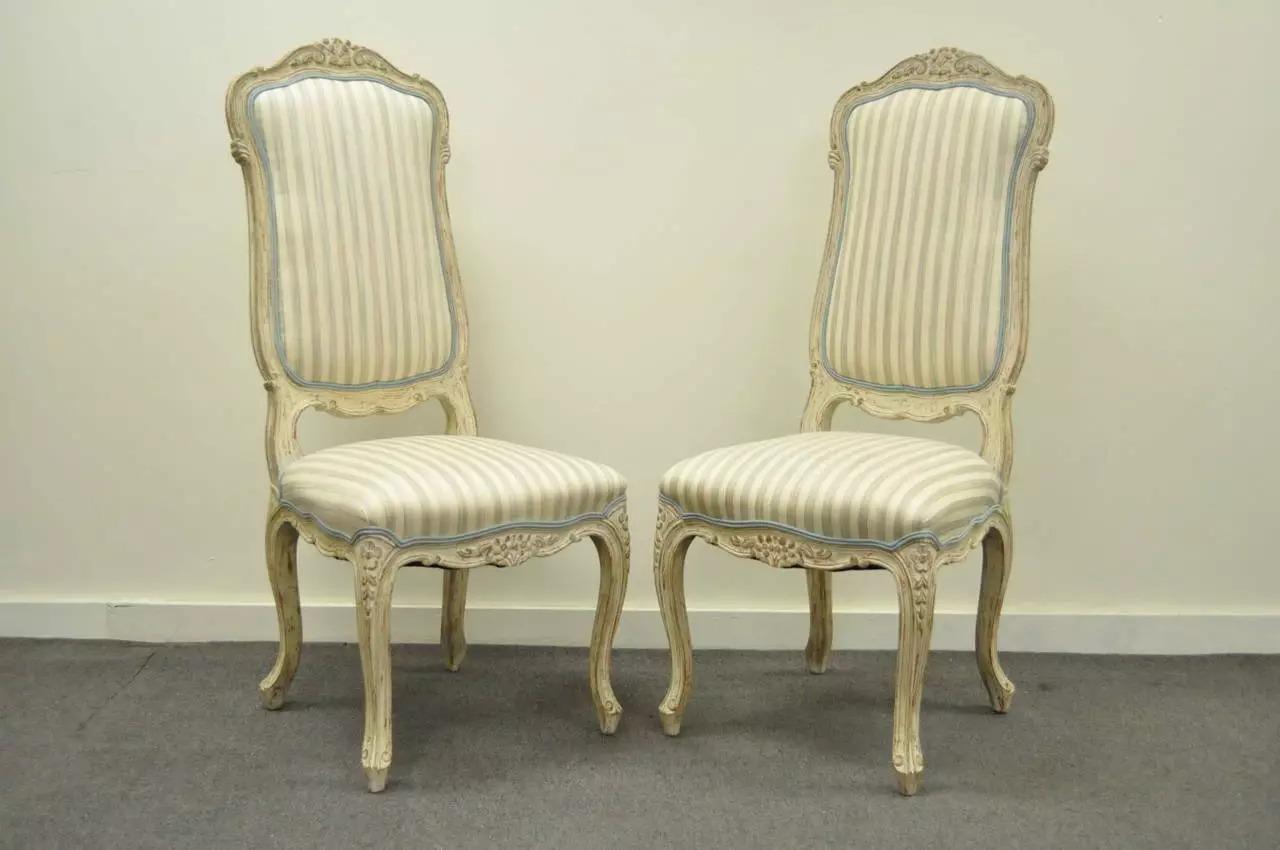 Great set of 4 vintage distress painted dining chairs in the Swedish Rococo / French Louis XV Style. Chairs feature shapely cabriole legs, carvings throughout including the crest, lower back rest, and rails, and classy elegant form. Circa Mid 20th