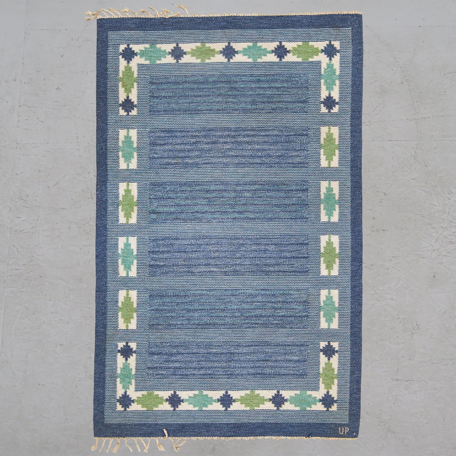 Wonderful Swedish flat-weave rug in various shades of blue and green with geometric border compositions. Signed UP.