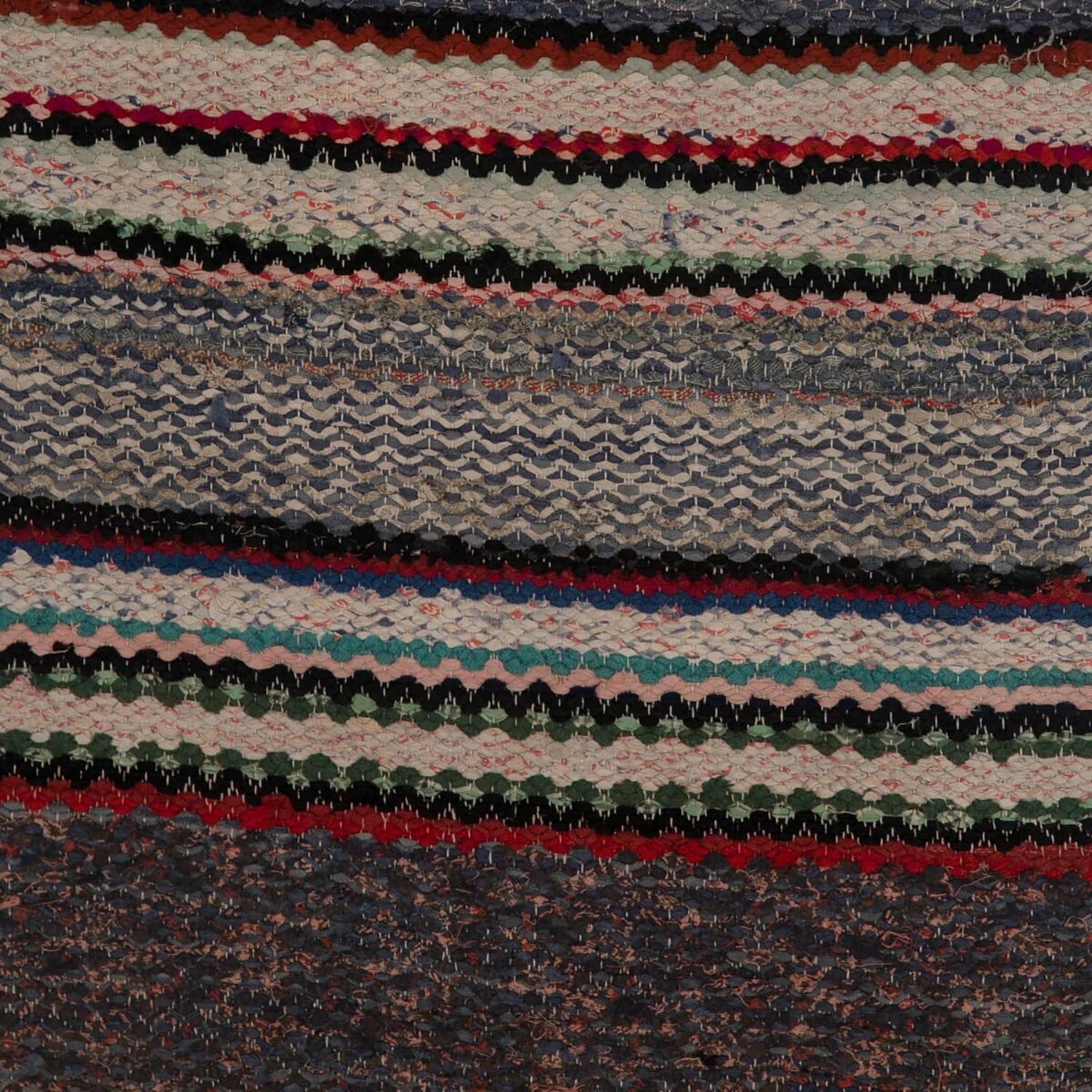 Vintage Swedish rug woven in the 1950s with tones of multi blue tones and a red accent stripe.