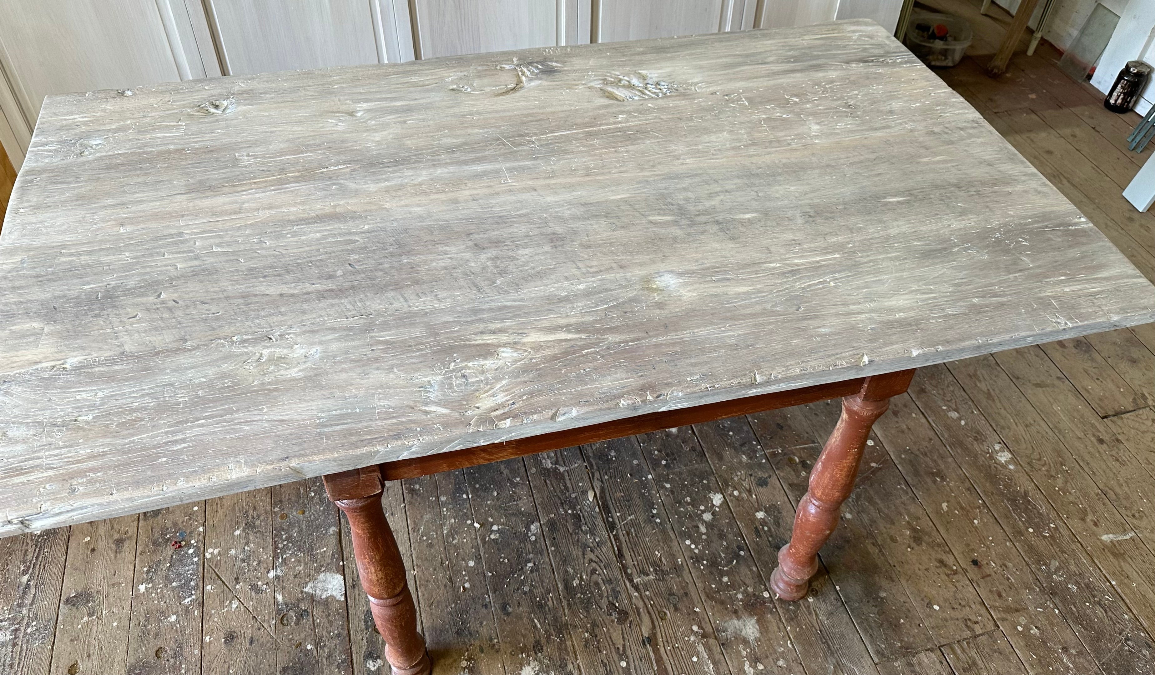 A timeless Swedish Gustavian inspired painted farmhouse table made with reclaimed whitewashed wood table top and a red painted colored wood table base. The table makes a perfect addition to any kitchen or dining room. Natural and rustic in