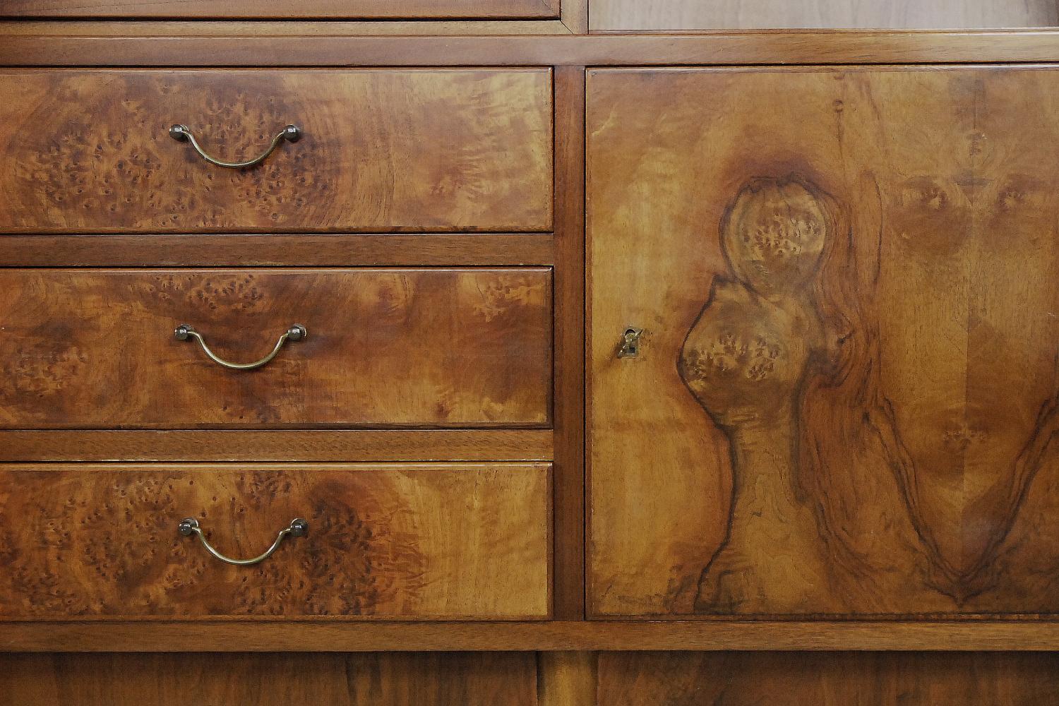 This cupboard was manufactured in Sweden during the 1940s. It is finished in walnut burl wood. A burl (or burr) is a tree growth in which the grain has grown in a deformed manner. It is commonly found in the form of a rounded outgrowth on a tree