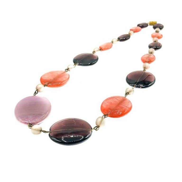 A Vintage Sweetie Glass Necklace. Featuring adorable hand made sweetie style flattened glass ovals with satin glass spacers. Threaded on metal wire and finished with a barrel clasp. In very good vintage condition, 65cms. A delightfully pretty piece.