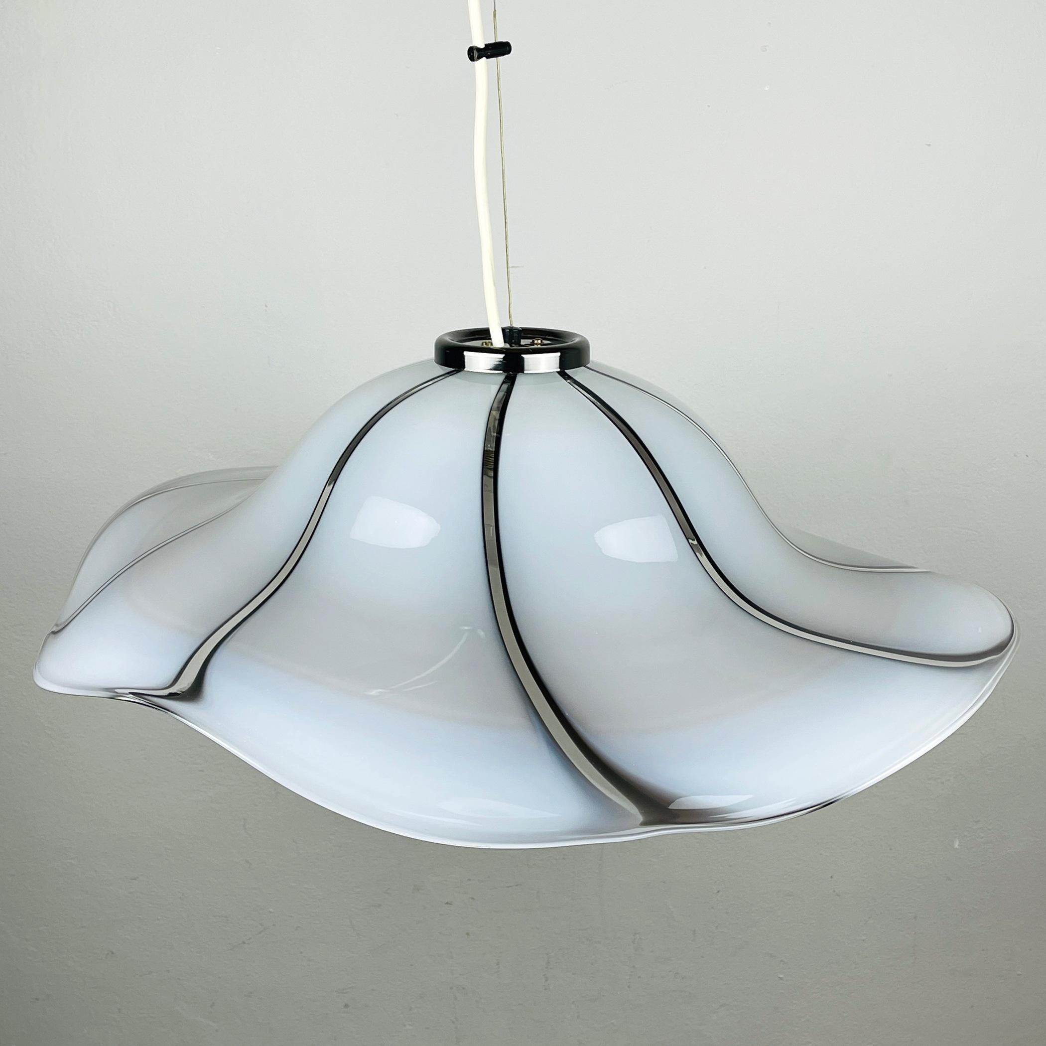Original large impressive Murano pendant lamp made in Italy, in the 1970s. The shade of this model, also known as 'Petticoat ', resembles a large women's hat. The shade is molded by hand. The lamp also displays some true Murano craftsmanship. These