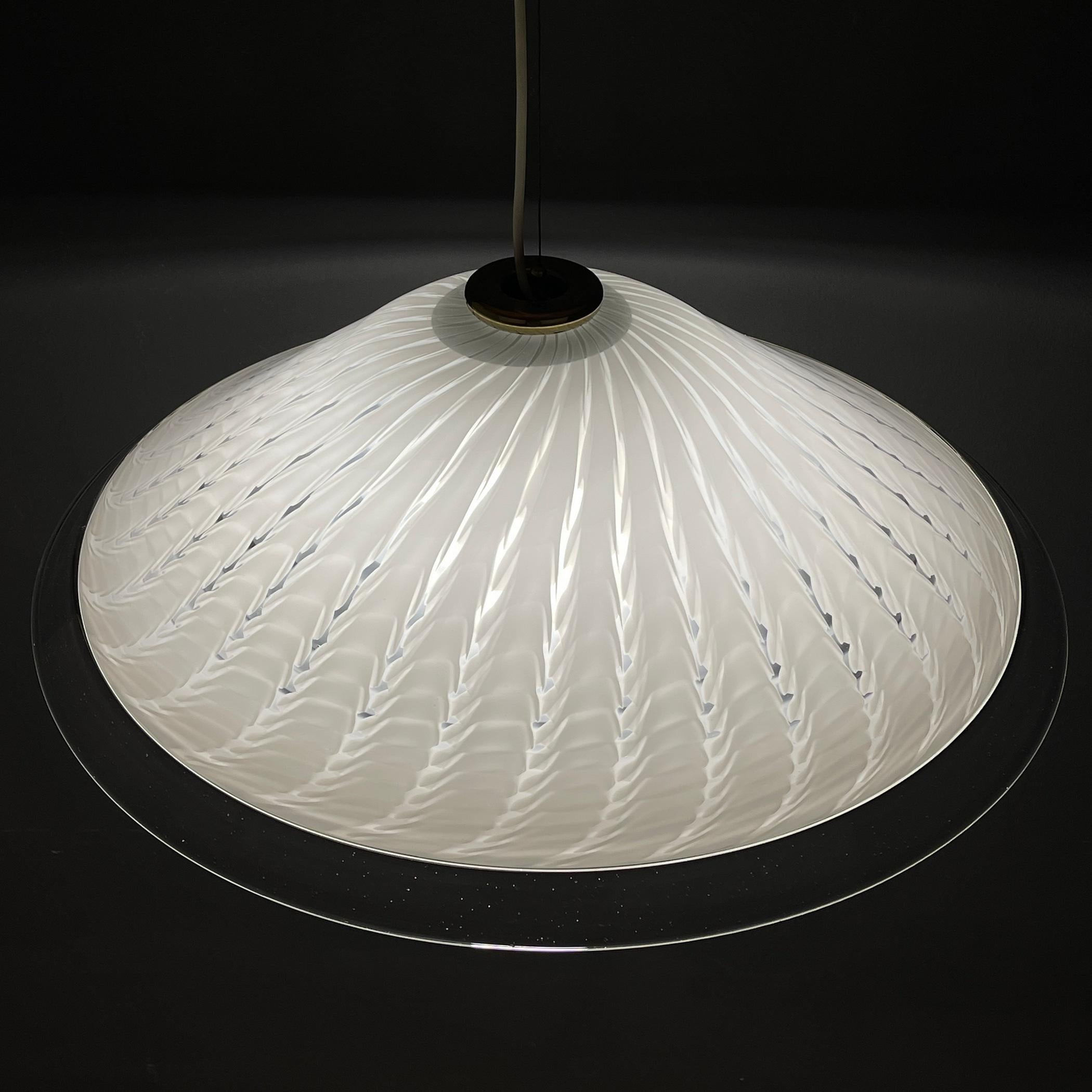 This swirl white Murano pendant lamp was made in Italy in the 1970s. Very beautiful white Murano glass with bends. Perfect vintage condition. No chips or cracks. Requires a standard Edison E27 with a screw lamp. Chandelier height with cable 110 cm.