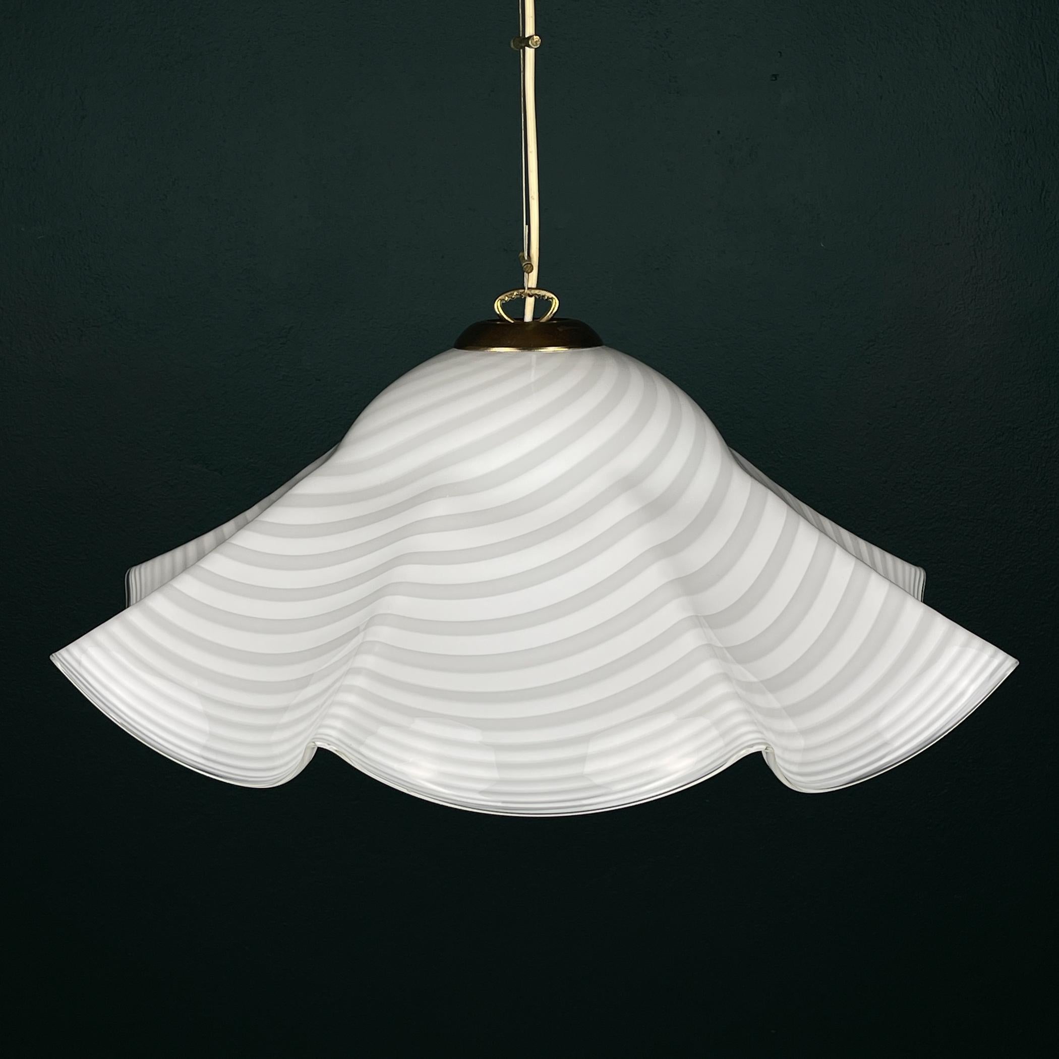 Vintage swirl white Murano glass pendant lamp made in Italy in the 1970s.

The lamp is in excellent vintage condition.

Dimensions:
Width: 60 cm / 23.6 inches
Height: 27 cm / 10.6 inches
Lamp height with cable: 100 cm / 40 inches

Lamp requires