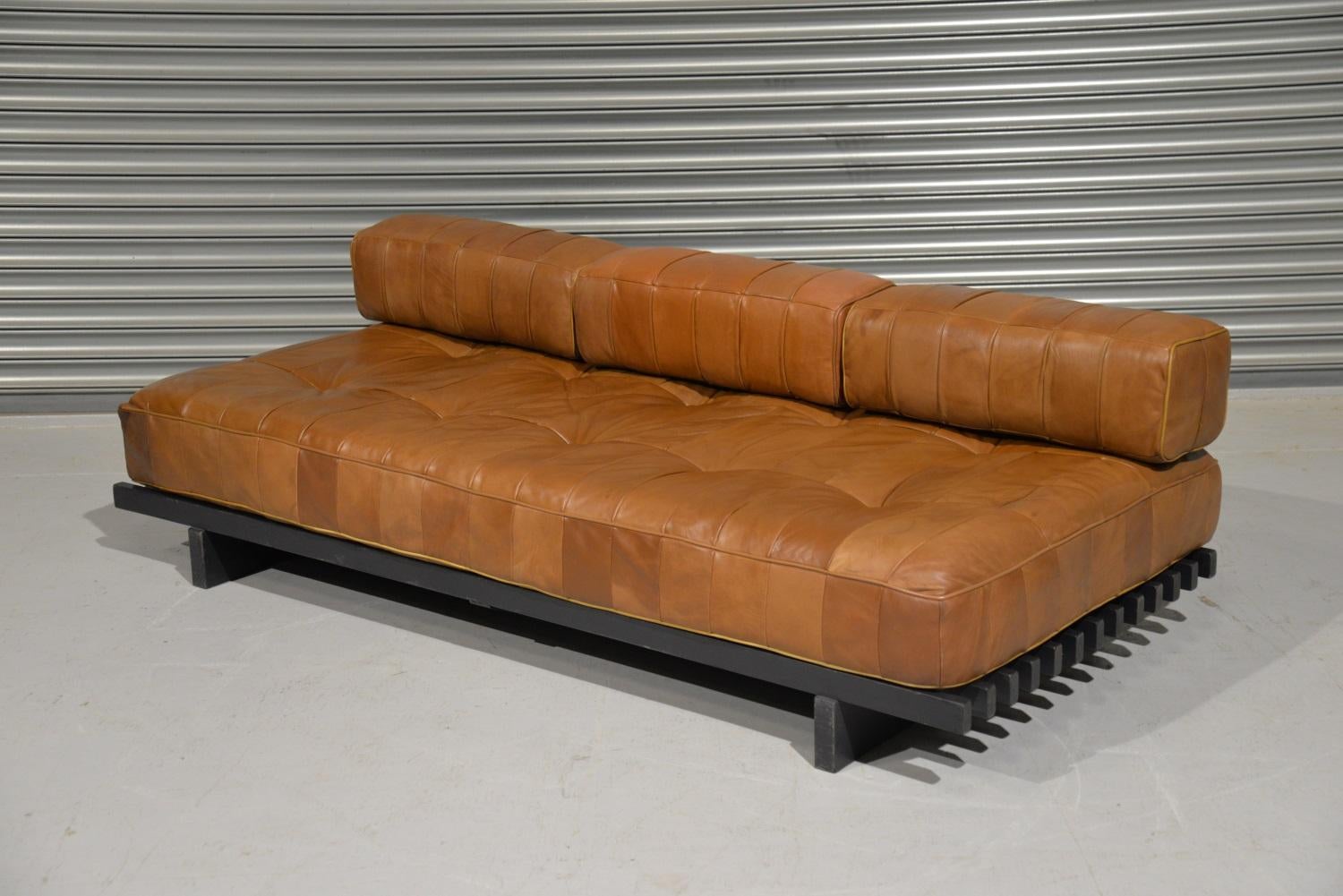 Discounted airfreight for our US and International customers (from 2 weeks door to door).

We are delighted to bring to you a rare and original De Sede DS 80 daybed with set of bolster patchwork back cushions. Built in the 1960s to incredibly high