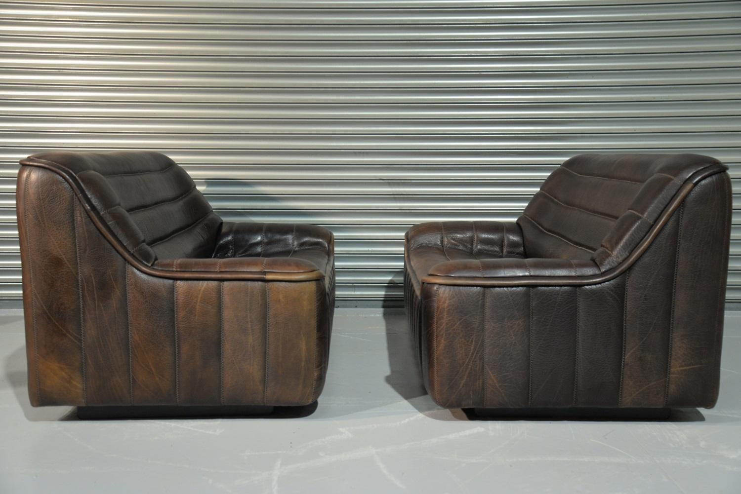 We are delighted to bring to you an ultra rare pair of vintage De Sede DS 84 2-seat sofas. Hand built in the 1970s by De Sede craftsman in Switzerland, these pieces are upholstered in thick brown neck leather with superb hand stitched detail. These