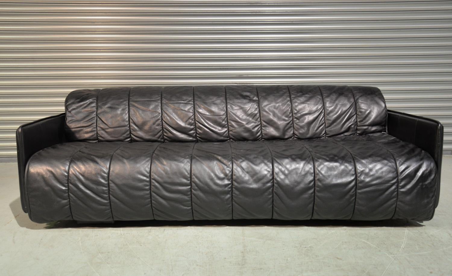 We are delighted to bring to you an ultra rare vintage De Sede sofa bed. Handmade by De Sede craftsman in Switzerland, this convertible sofa bed is upholstered in stunning soft black quilted aniline leather. It's amazingly comfortable, the front