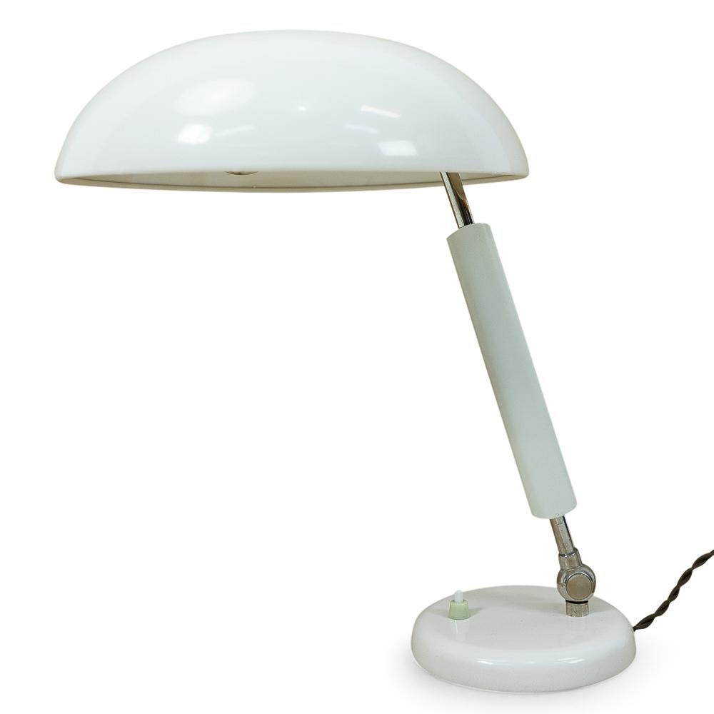Authentic vintage Swiss produced desk lamp, 1950s.

This lamp features an aluminum lampshade and heavy base. The angle and height of the lamp shade can be adjusted.

 
Condition: Excellent, new electric wiring, limited signs of