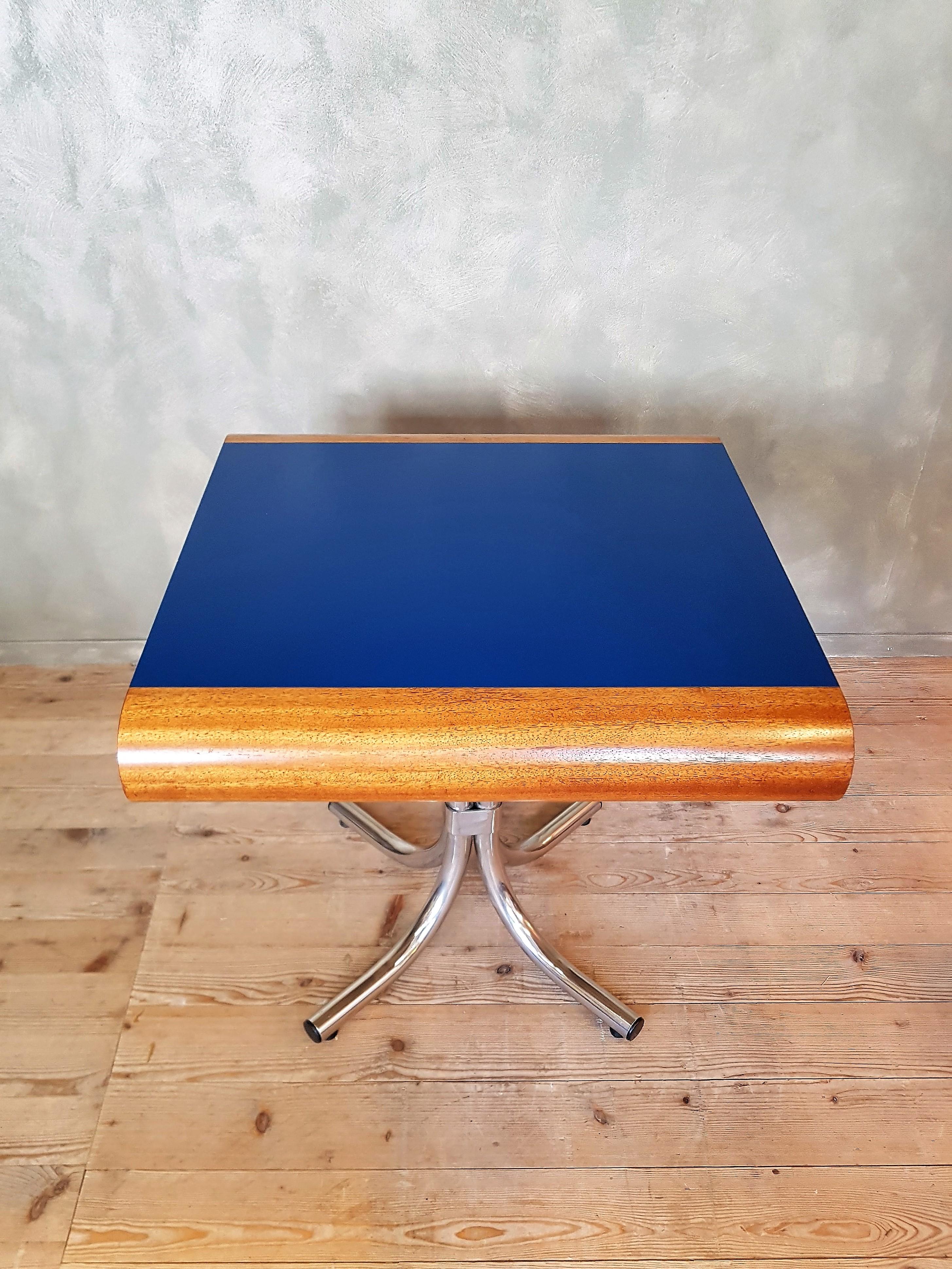 A table with curved sides and a royal blue middle section, what stands in contrast to the chrome base. Designed by architect Jürg C. Schindler from Zurich, produced in a limited edition of only very few tables.
