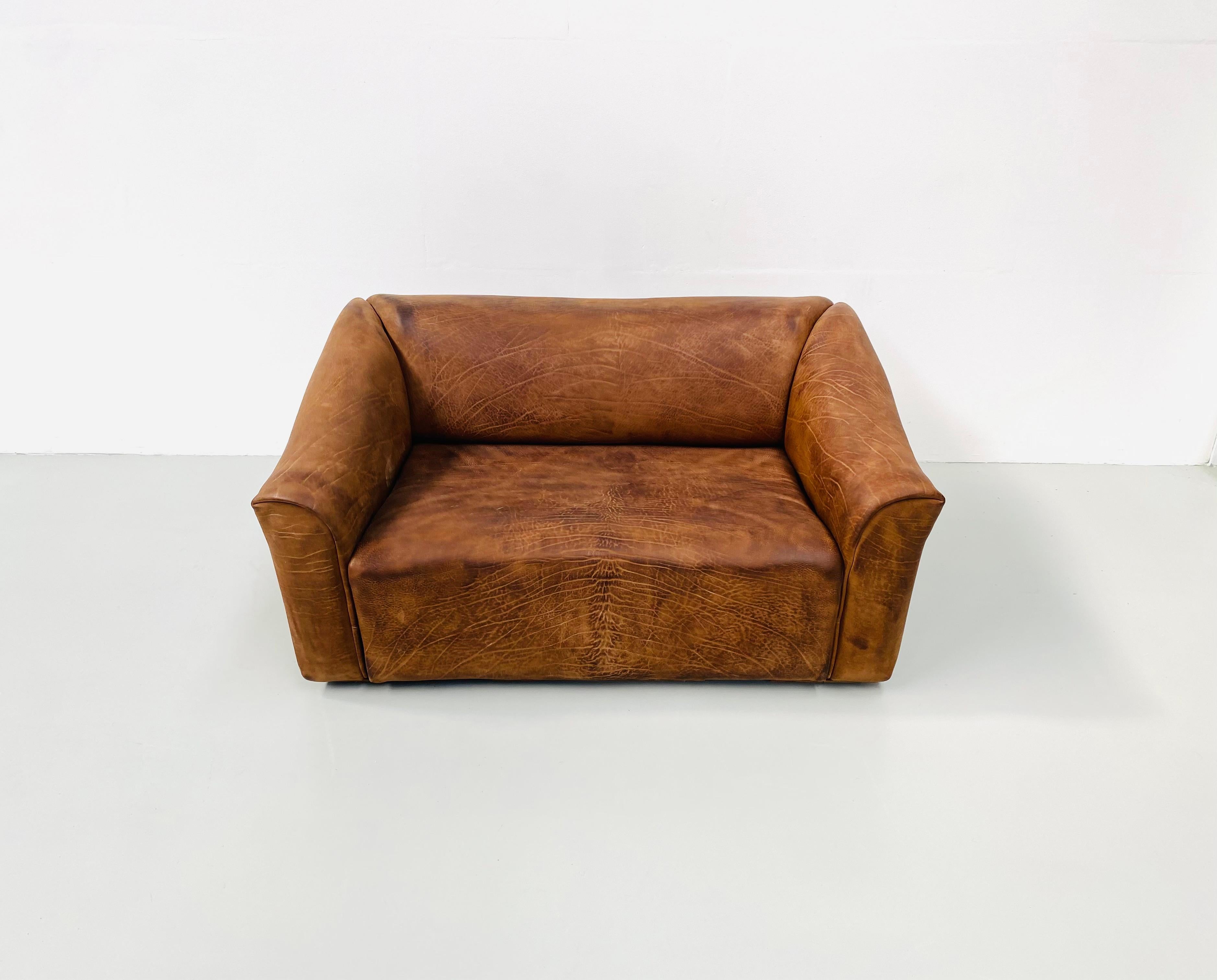 The iconic DS-47 Sofa was designed by the De Sede team in the seventies. This mid century sofa is made of 5mm thick NECK leather recognizable in characteristic fat wrinkles with great patina. The different textures of the NECK Leather and the fat