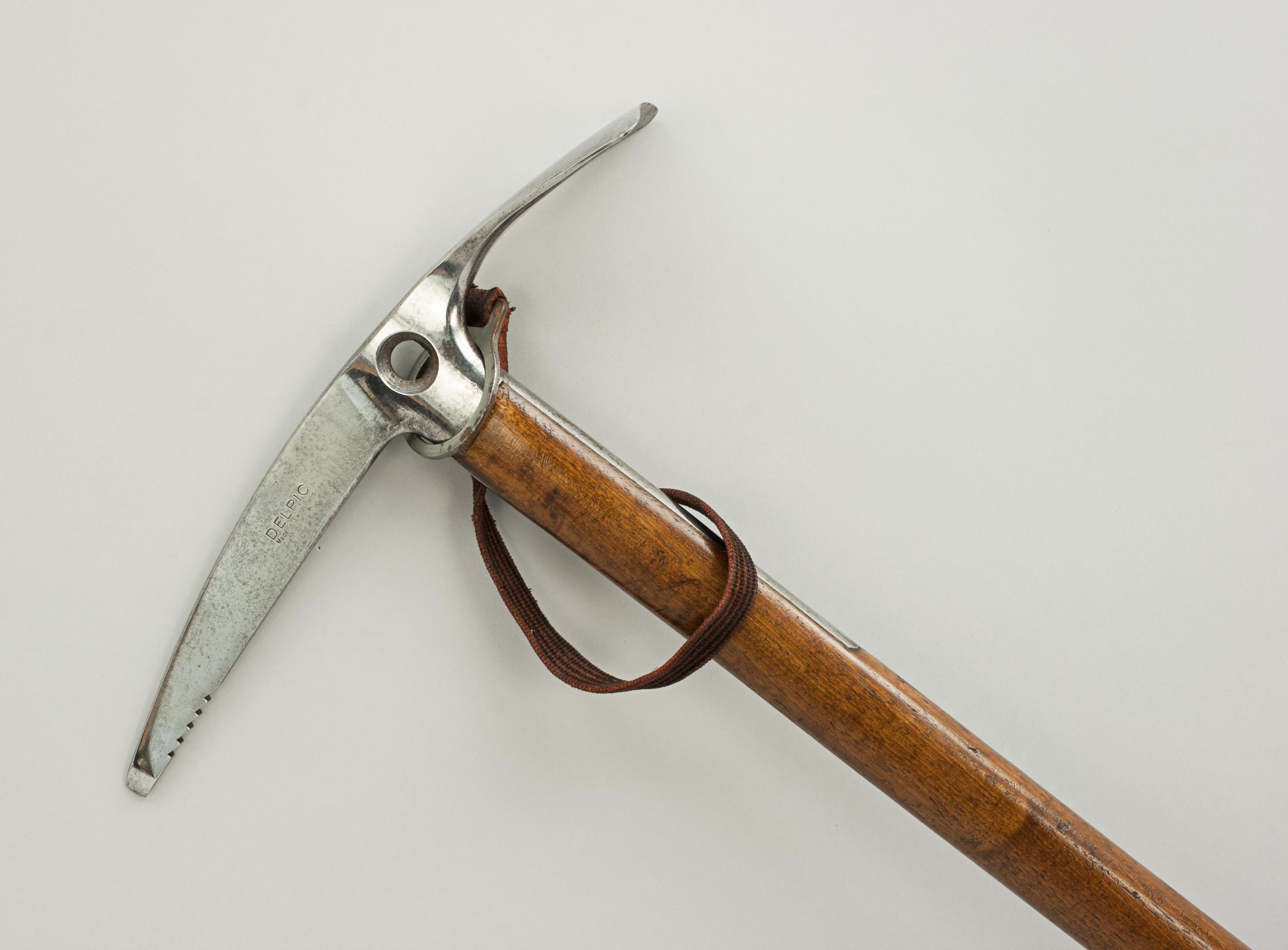 A good 'DELPIC' ice axe, the handle is made from ash with a good serrated steel pick and with a wide adze. This is a Fine quality ice pick with a hole in the head for a securing leash, a pointed flat spike and a metal ferrule. The head is stamped
