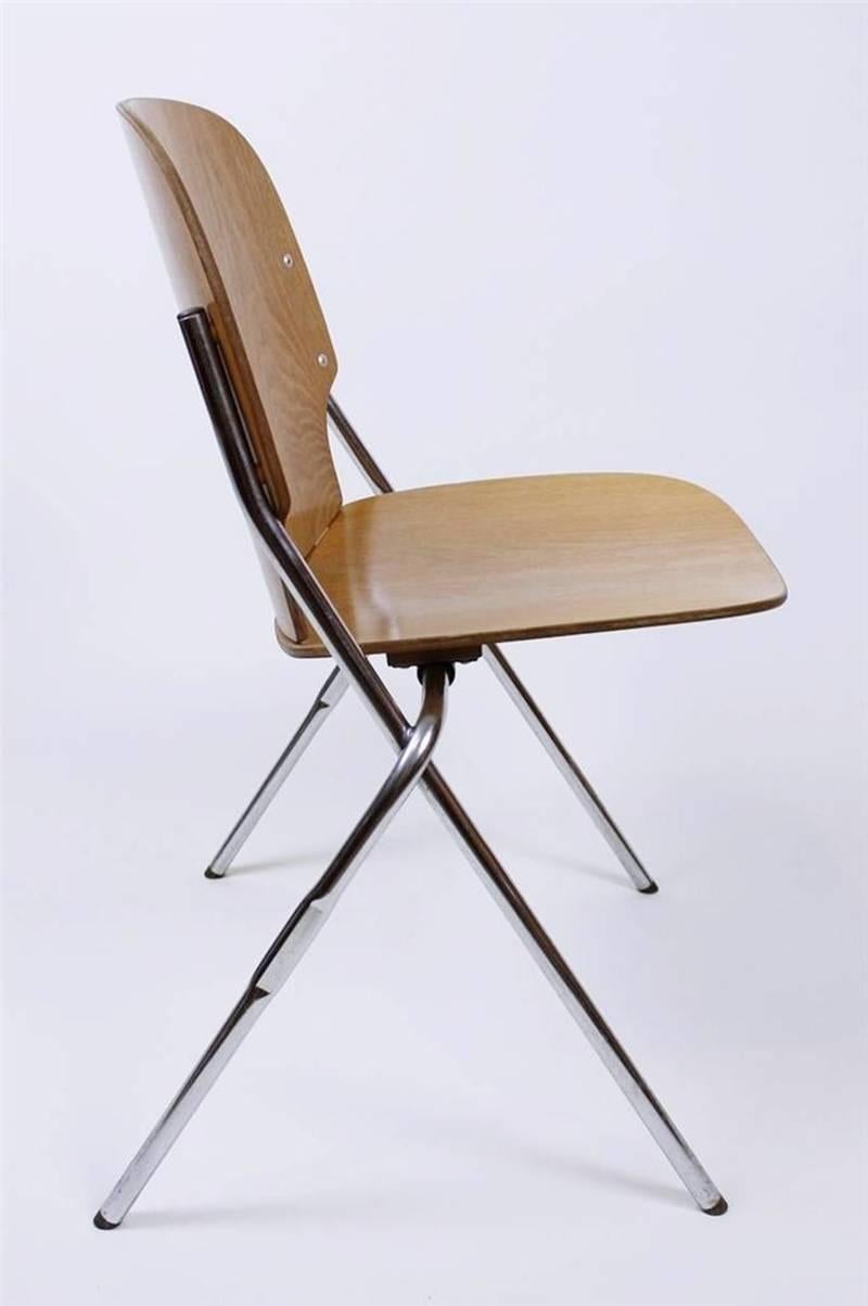 A vintage chair made by Swiss Industrial furniture company Embru, circa 1960s. The chair combines a curved ergonomic seating element with a linear base with strict, architectural lines.