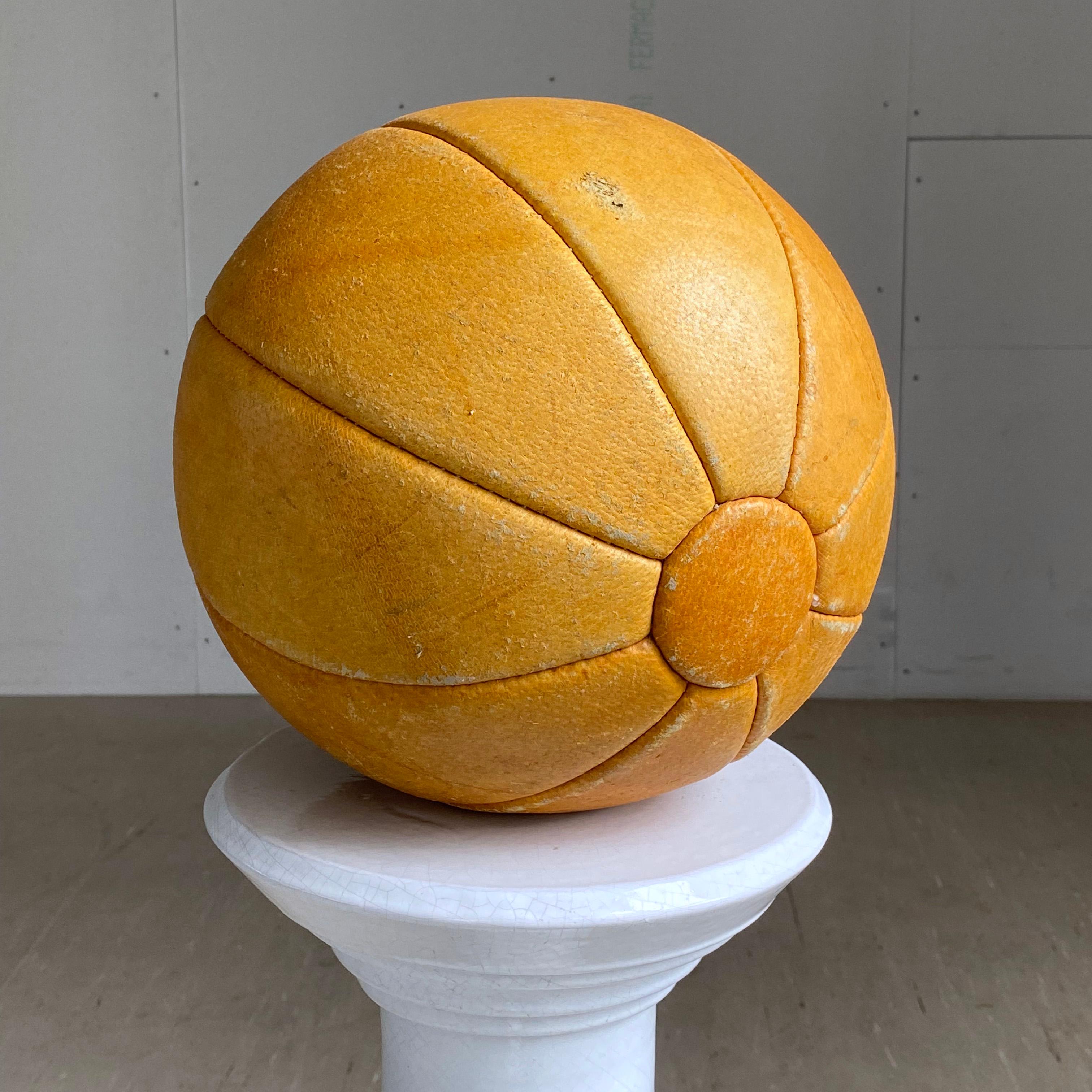 Vintage Swiss Mid Century Leather Medicine Ball with light patination. 
Weight: 2Kg's
Diameter: 25cm's
Great decorative item which suits all decorative styles, with functional use in a gym or for personal training.
