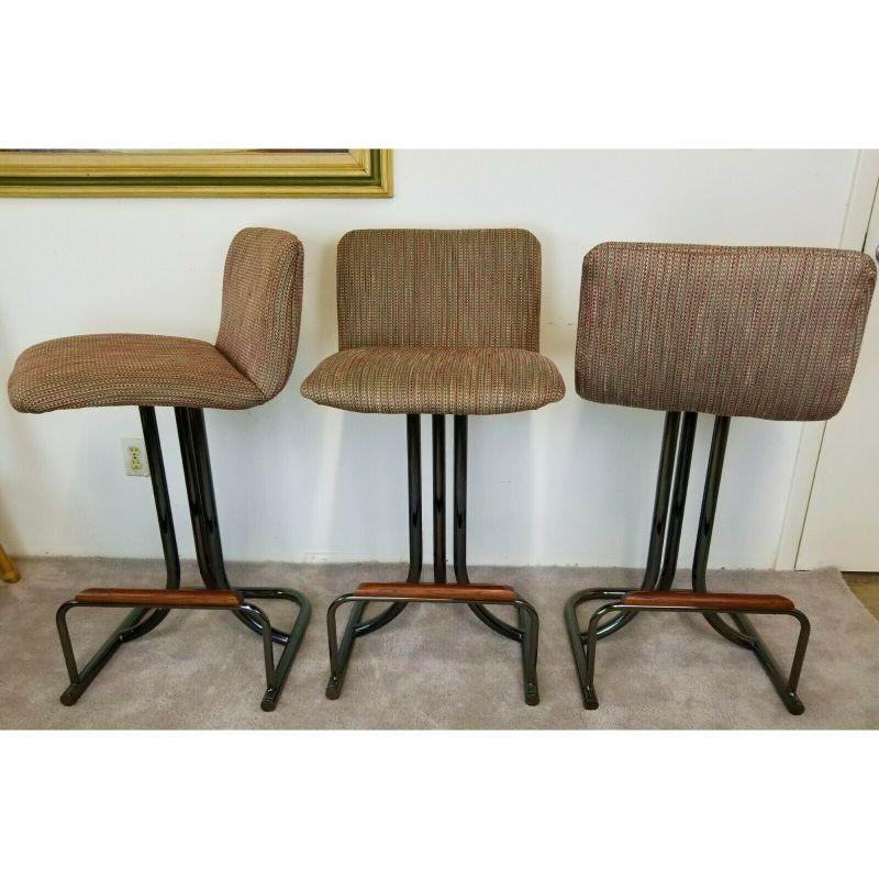For FULL item description be sure to click on CONTINUE READING at the bottom of this listing.

Offering One Of Our Recent Palm Beach Estate Fine Furniture Acquisitions Of A
Set of 3 Vintage Black Chrome Upholstered 360 Degree Swivel Barstools