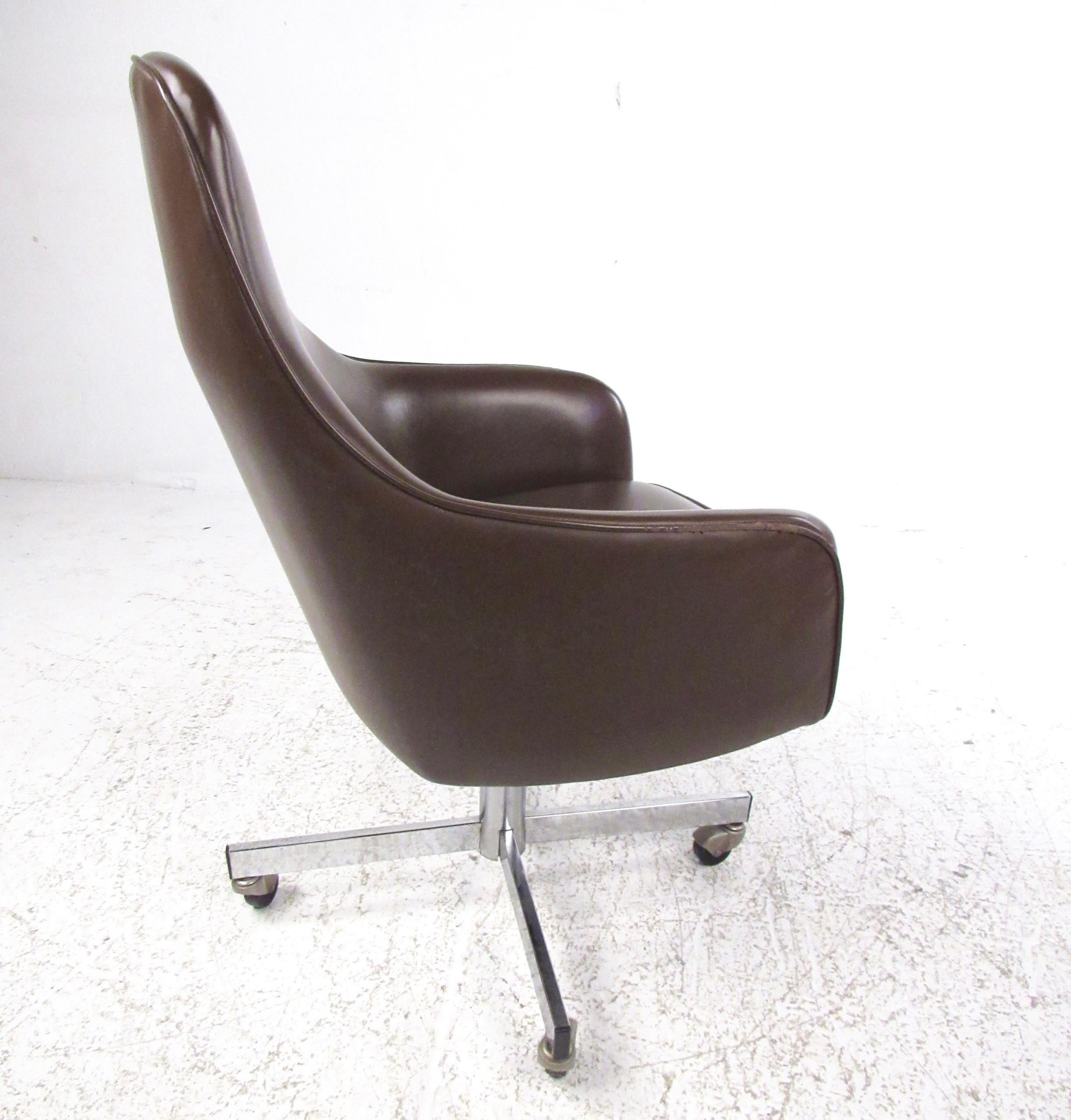 This high back desk chair features shapely vinyl swivel seat and sturdy metal base. Stylish Mid-Century Modern design adds retro appeal to home or business office. Fixed seat height of 18 inches, seat tilts for comfort. Please confirm item location