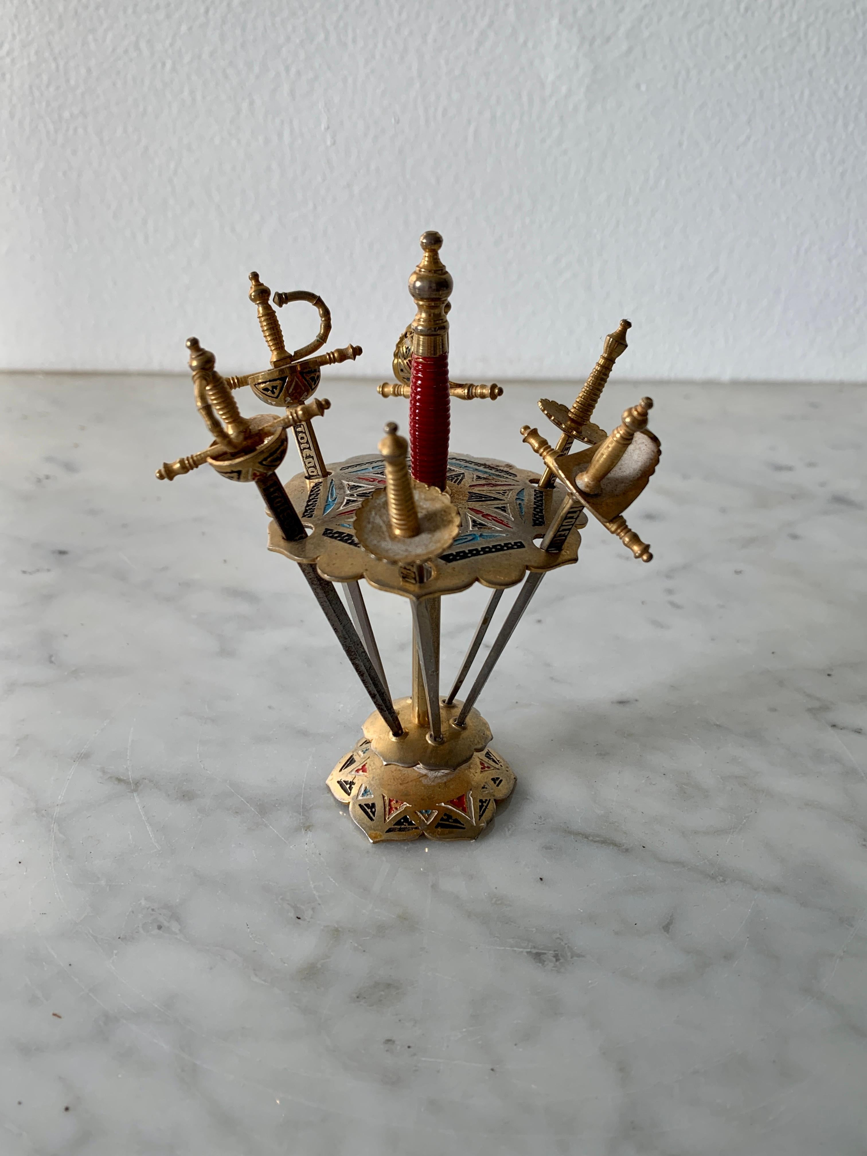 A charming set of six cocktail picks shaped as a swords on a stand

Circa 1960s

Measures: 3