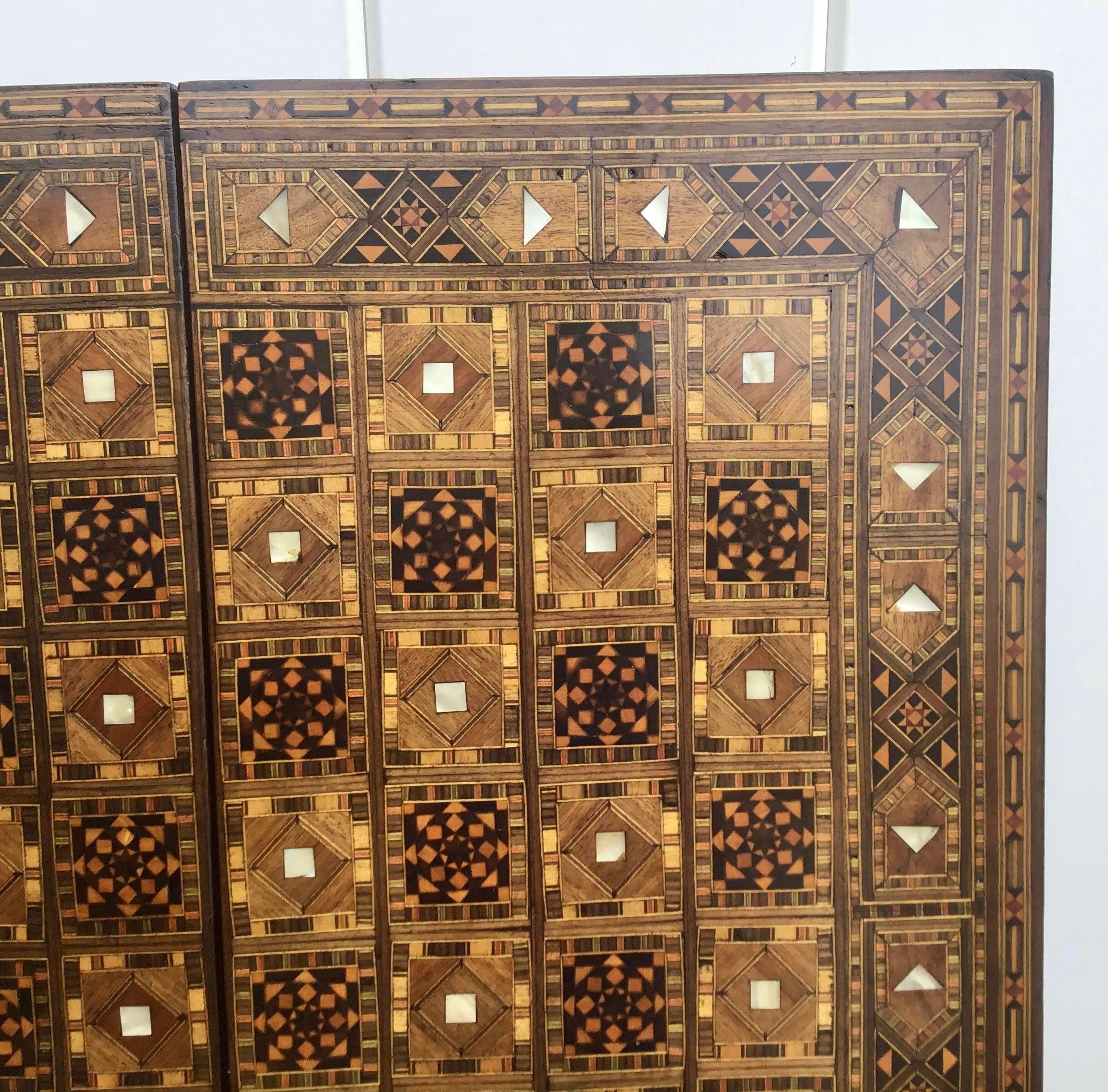 Large vintage Syrian inlaid with mother of pearl mosaic backgammon and chess game board. Great inlaid micro mosaic hinged marquetry game board features a chess and checker board on the exterior and felt board on the interior. Displaying intricate