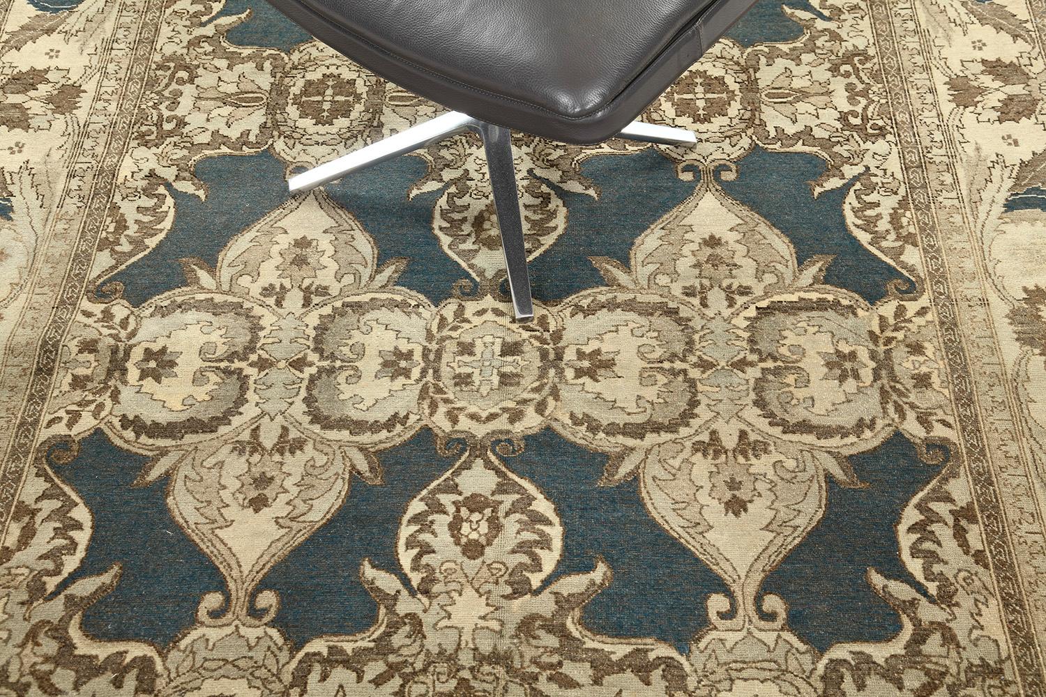 An amazing revival of Arts and Crafts Style rug that features elegant neutral tones. Fabricating gracefully in an opaque midnight blue field, the mirrored pattern is well-coordinated and matches the theme. Ornamental embellishments are formed