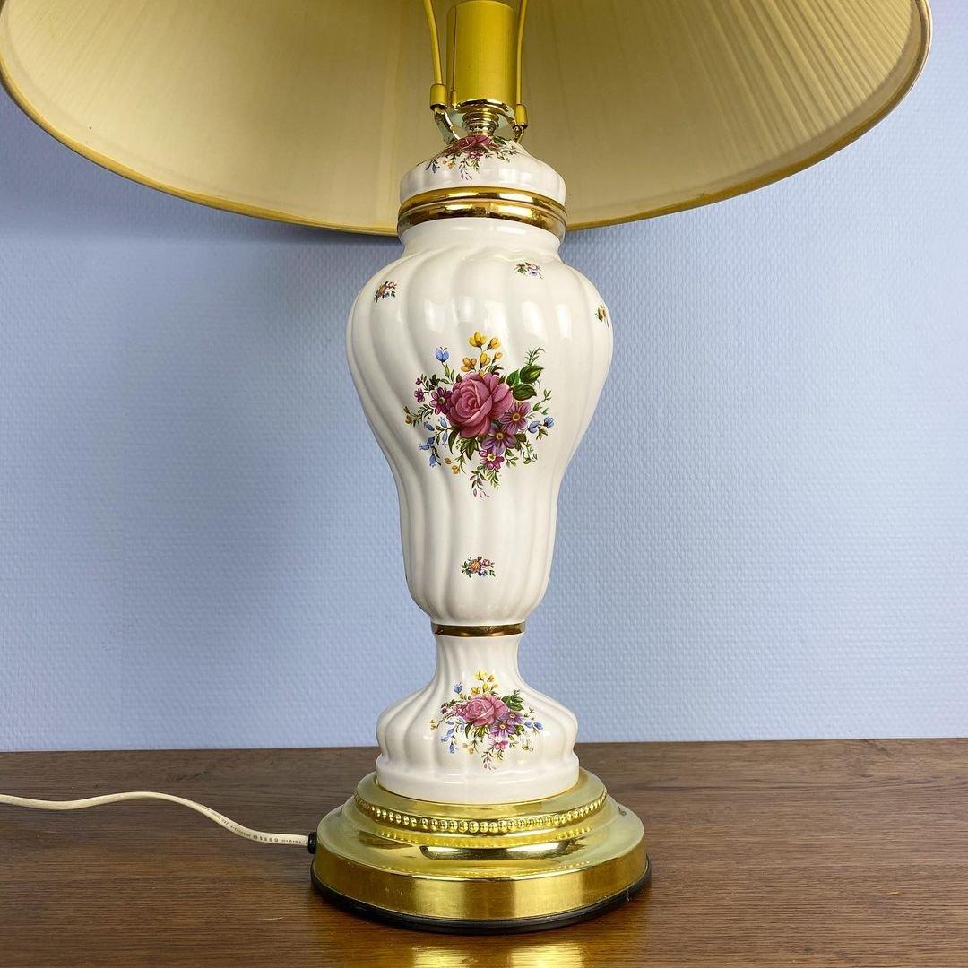 Vintage-inspired porcelain table lamp hand-painted from scratch to deliver that stunning and intricate decorative detailing. The lamp sits on a rounded base for support and features beautiful flower imprints all over that will impress everybody who