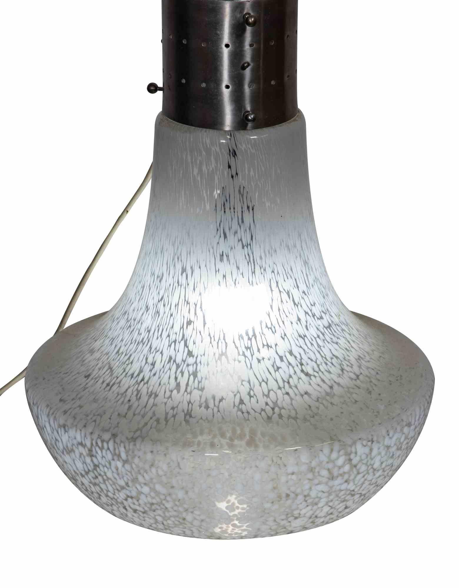 Table lamp is a Mid-Century Modern floor lamp realized by Carlo Nason.

Produced in Italy.

This lamp is realized by two elements in murano glass connected by a steel part in the center.

Carlo Nason was born into a family of expert