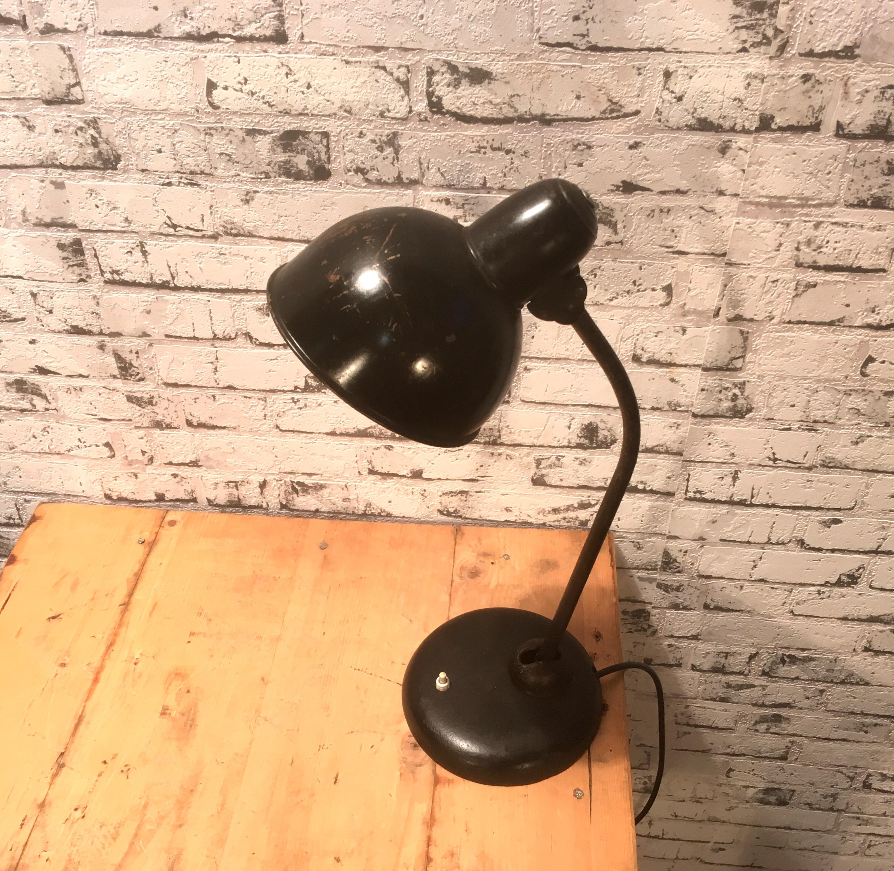This table lamp was designed by Christian Dell and produced by Kaiser Idell during the 1930s. It is labeled and in very good vintage condition. Fully functional.
