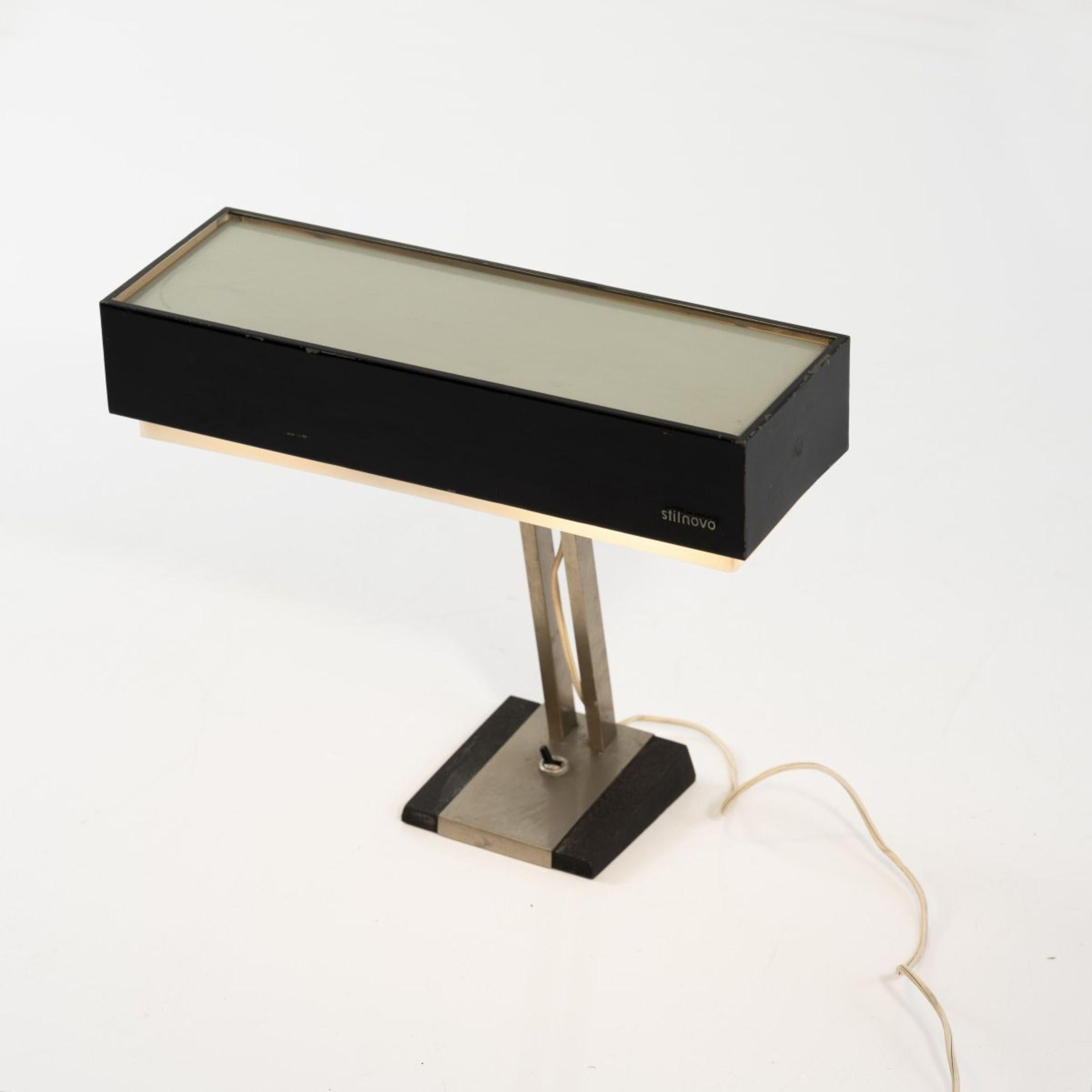 Stilnovo table light is an original decorative object realized in the 1960s by the Italian Factory Stilnovo, Milan.

Made and created by Stilnovo. 

Marked: Stilnovo.

Main materials: metal tube, sheet metal, painted black and grey, acrylic