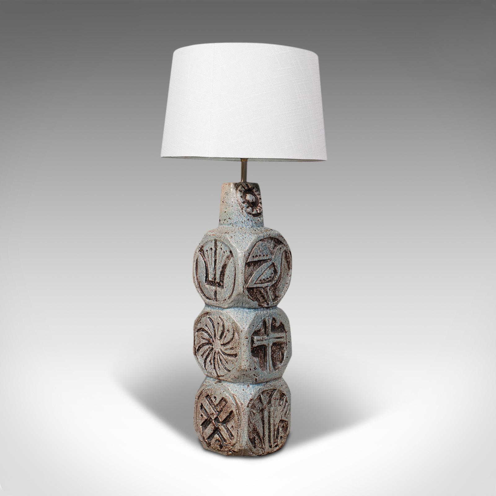 This is a vintage table lamp. An English, ceramic side light in the manner of Troika, dating to the late 20th century, circa 1980.

Distinctive base with appealing decoration
Displaying a desirable aged patina and in good order
Ceramic finished