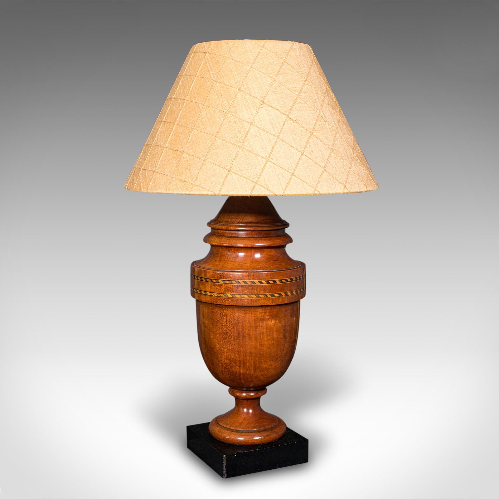 This is a vintage table lamp. An English, turned walnut and boxwood side light, dating to the mid 20th century, circa 1950.

Presents wonderful figuring and delightful turned craftsmanship
Displaying a desirable aged patina and in good order
Select