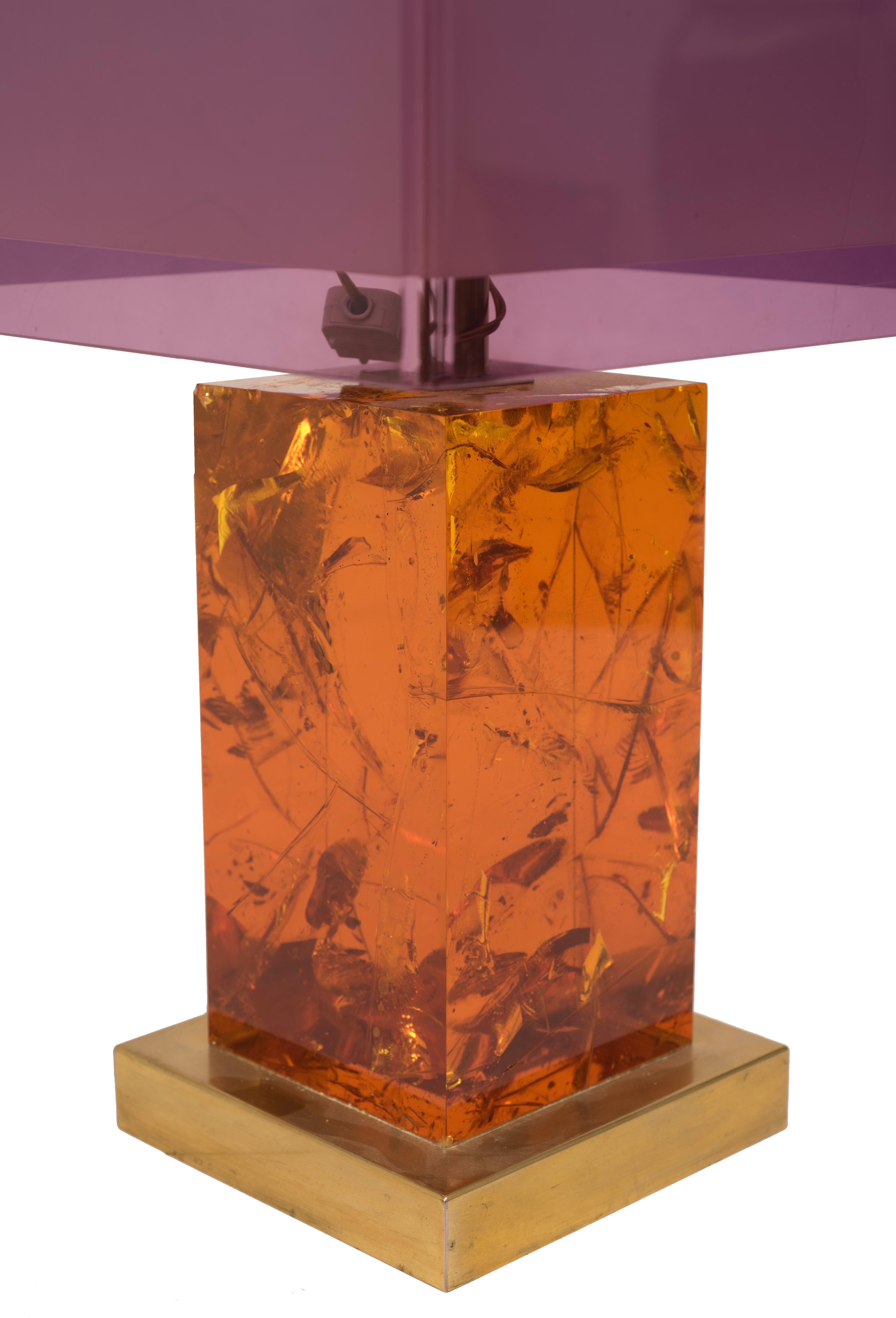 Vintage Table Lamp is an original design lamp designed by Italian Manufacturer in the 1970s.

Base in gilded brass, parallelepiped stem in amber resin. Double cube plastic hat with opal interior. The outer part is transparent and purple colored.