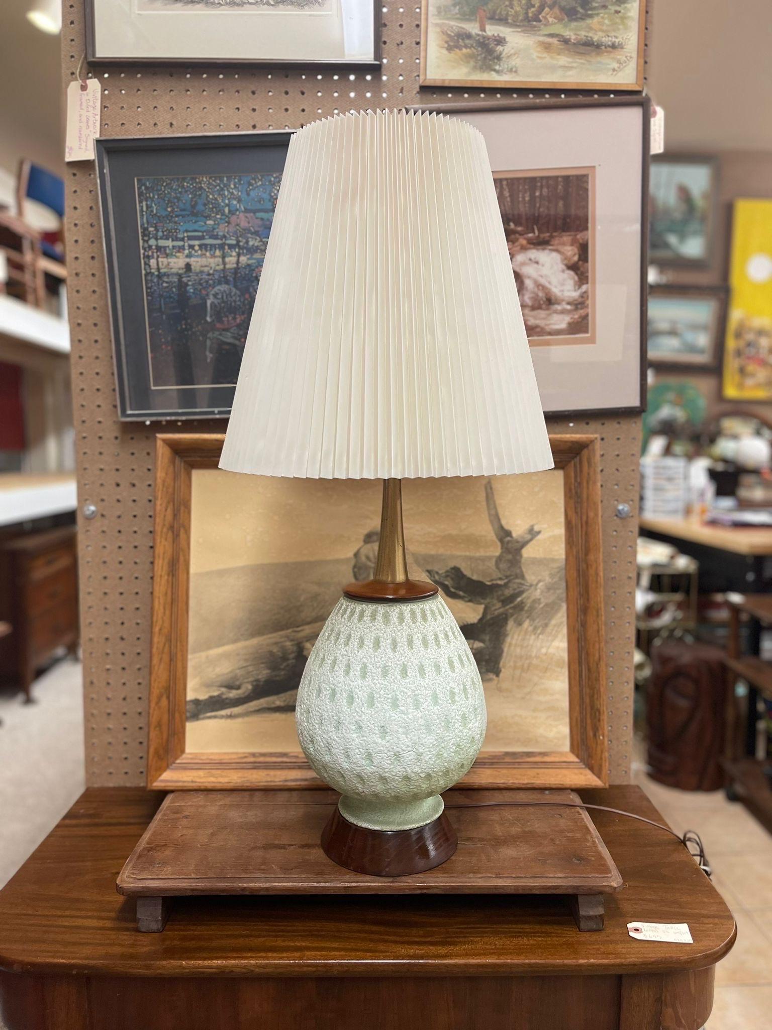 Ceramic Base is off White Tinted Green as Pictured. Pleated Tall Lamp Shade is Included. Operational Ability Unknown. Brass Toned Hardware,walnut Tone Wood. Nice Aged Aspects throughout. Vintage Condition Consistent with Age as
