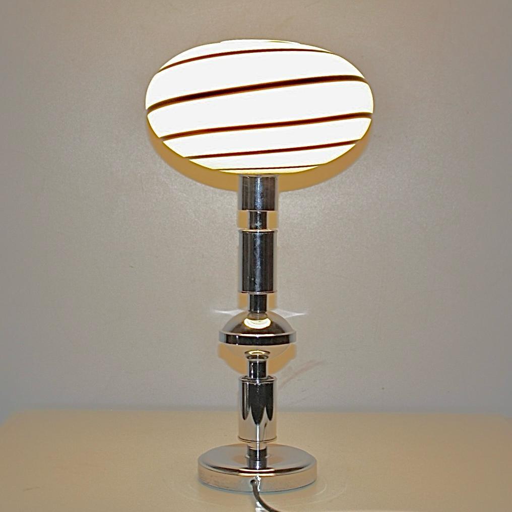 Vintage Table Lamp with Zebra Murano Glass, Italy 1970s. 

A beautiful 1970s vintage Murano table lamp with chromed structure.
The lamp is composed by an oval Murano glass with beautiful black and white glass pattern with a spiral shape. The iron
