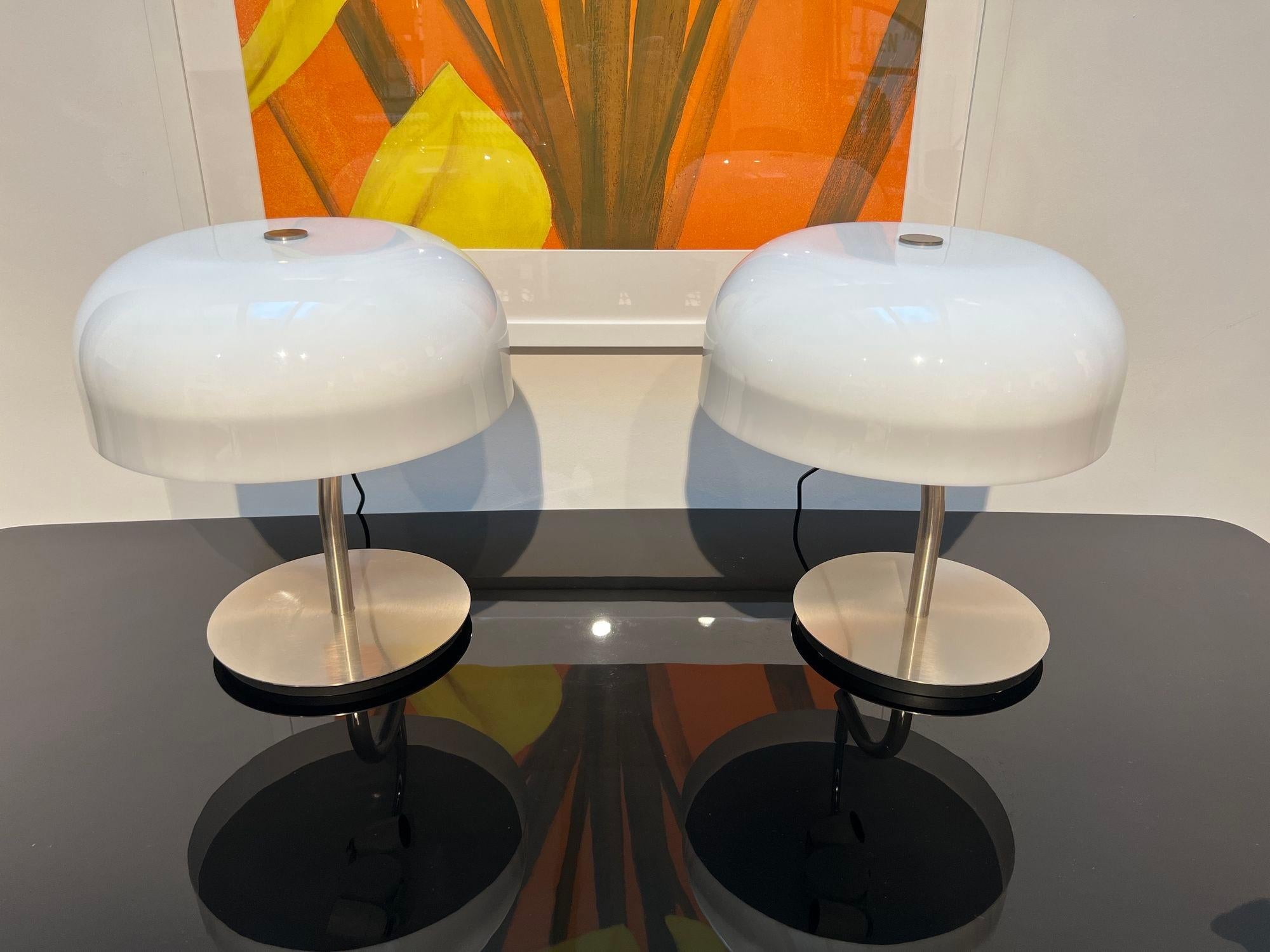 Vintage table lamps by Giotto Stoppino for Valenti Luce, Italy circa 1970s.
Brushed stainless steel frame. Can be swiveled outwards.
White acrylic glass shade, lower half illuminated. Inside 2 light sources. Switch on the cable.
Fully functional