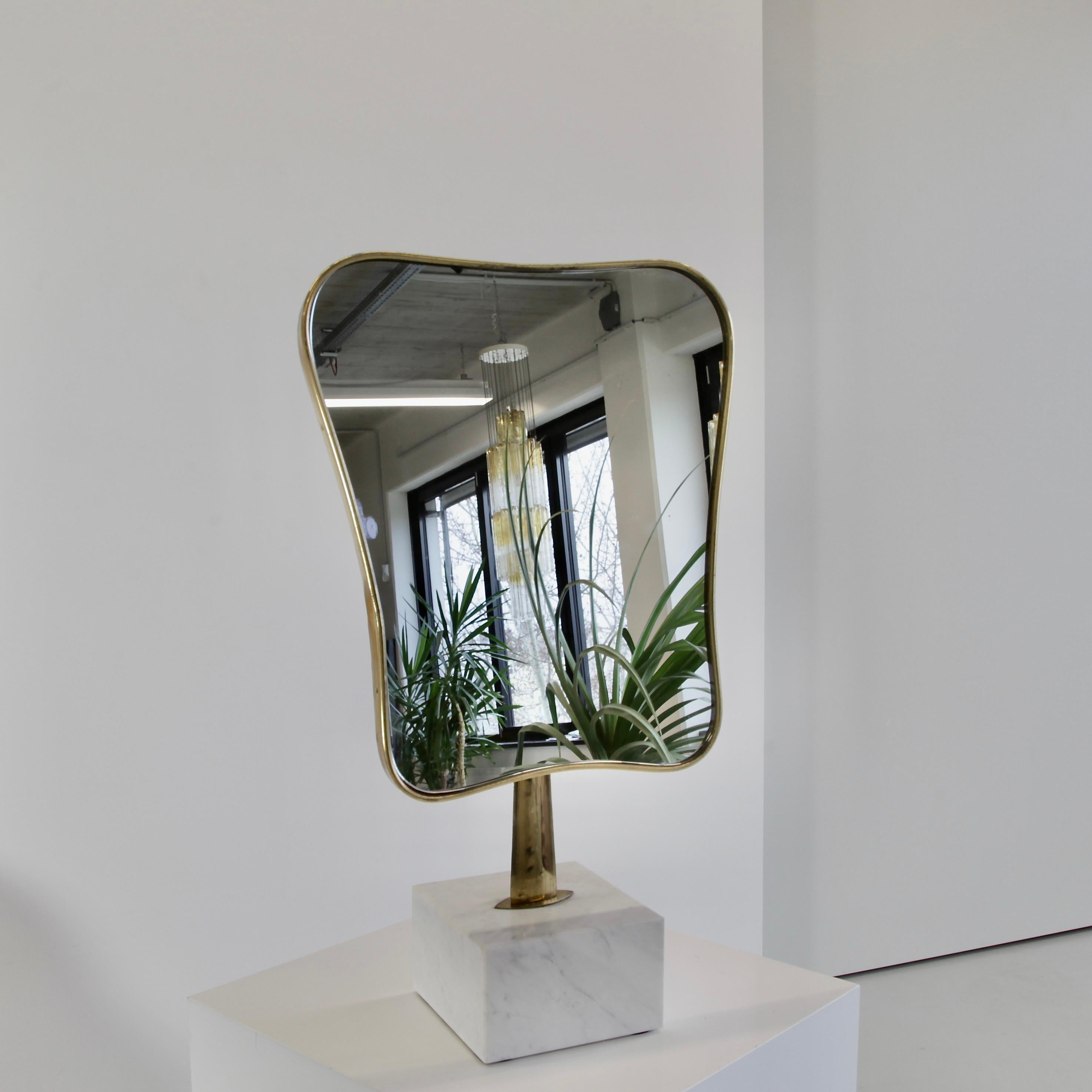 Table mirror with marble base. Italy, 1960's.

Organic design brass frame with the mirror glass insert, brass stem and heavy Carrara marble base. Super elegant table mirror/ sculpture. The mirror glass has been replaced with a new