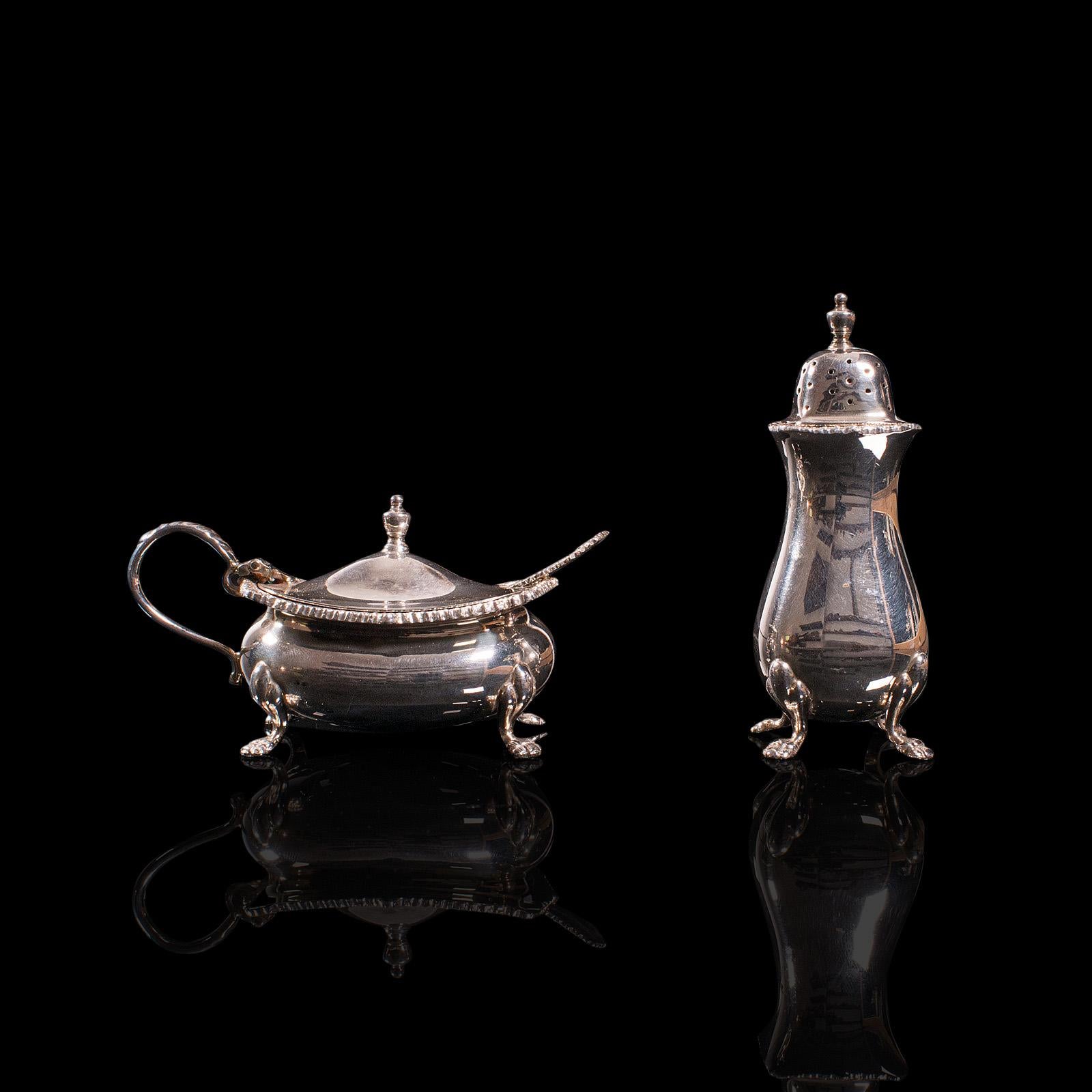 This is a vintage tableware set. An English, silver plate mustard pot and pepperette, dating to the mid 20th century, circa 1950.

Charming two-piece set for the dinner table
Displaying a desirable aged patina and in good order - some tarnish to