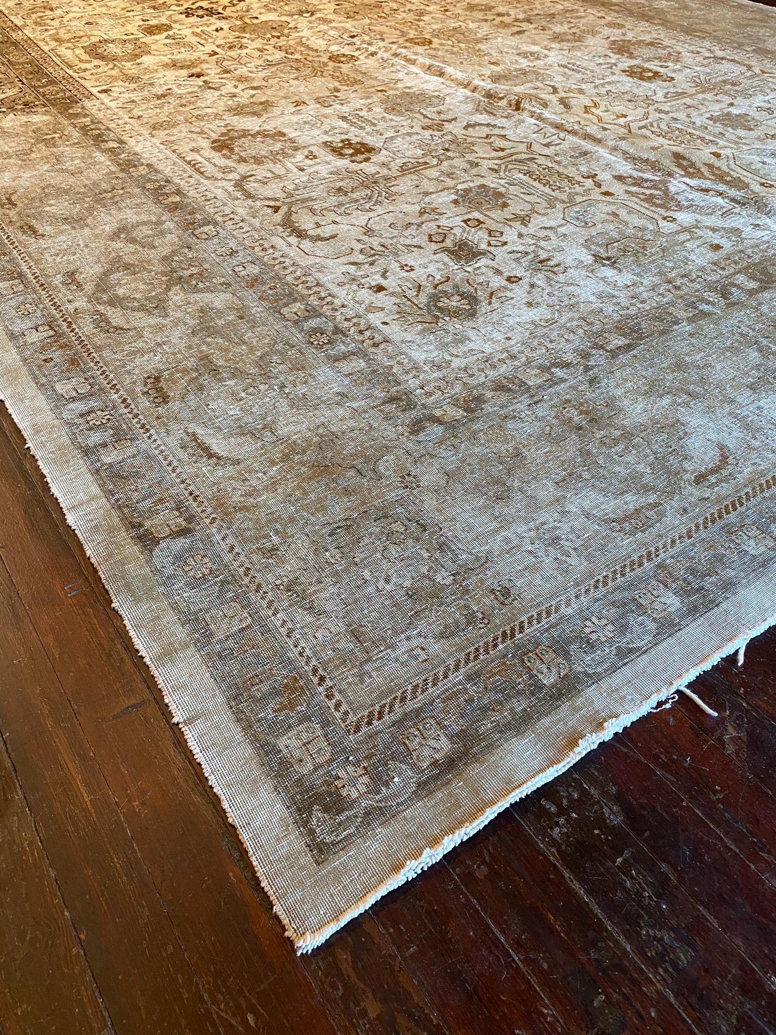 Tabriz rugs are known for their intricate designs and superb quality, and this particular piece showcases a muted yet elegant color palette that exudes sophistication and timeless beauty. Here's a detailed description of this exquisite