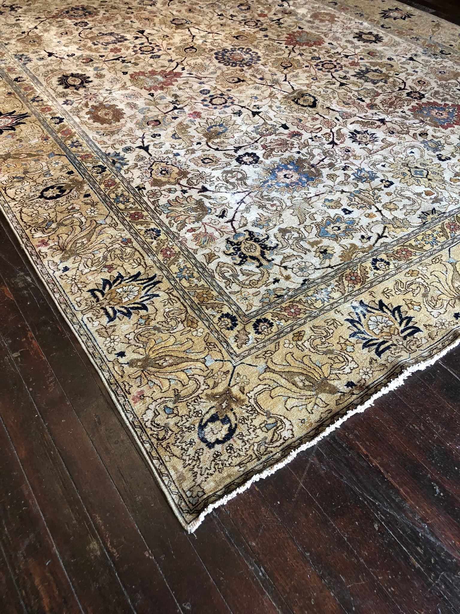 A Vintage Tabriz Rug is a testament to the timeless beauty and craftsmanship of Persian rug-making, known for its intricate designs and rich color palettes. This particular rug, with dimensions of 8 feet 8 inches by 11 feet 9 inches, is a classic