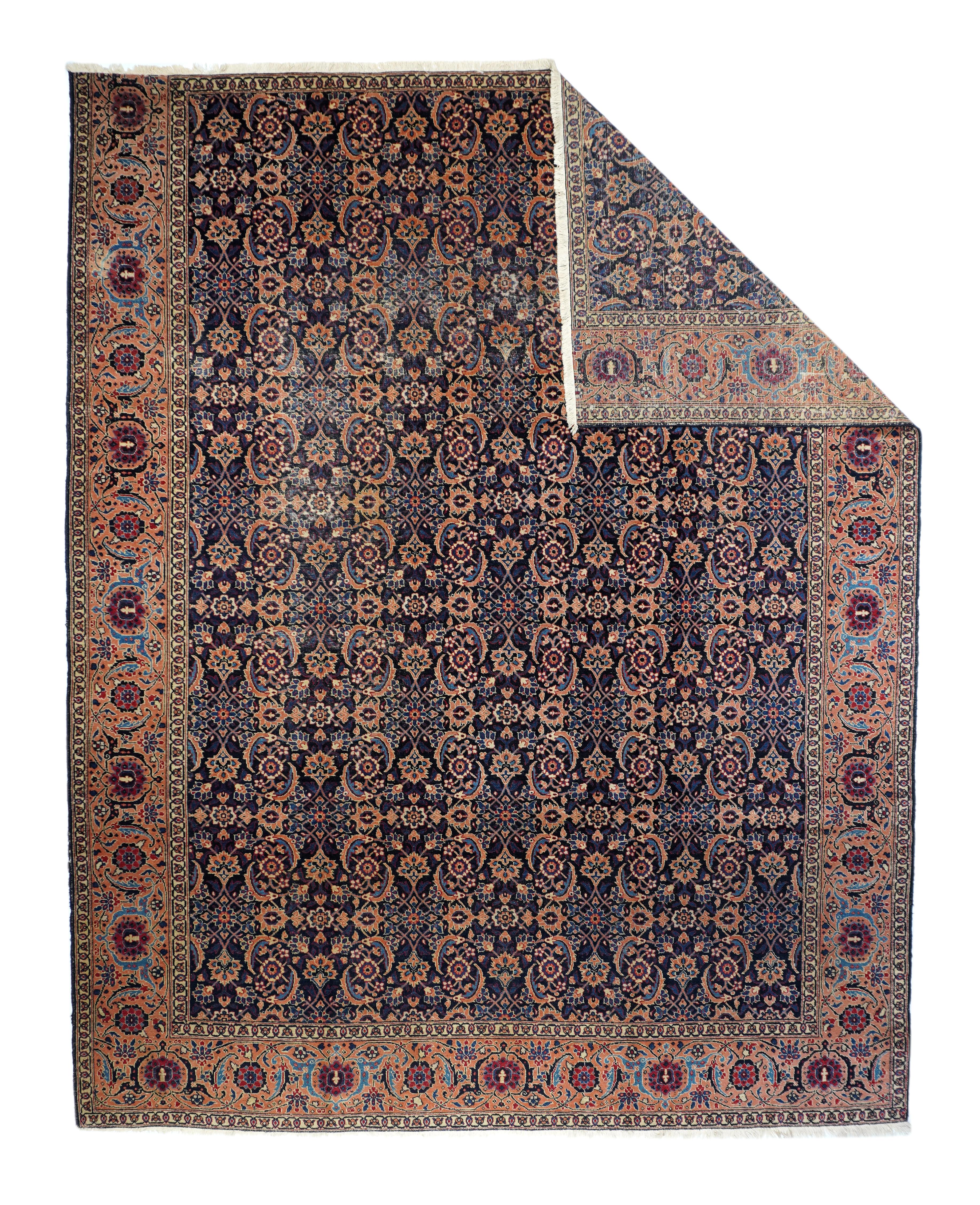 Vintage Tabriz Rug 8'10'' x 11'2''. The allover Herati pattern on navy creates a six-column over pattern of rosettes and swirling sickle leaves. Light blue accents. The pink border is three sided with an open reversing turtle and rosette pattern.