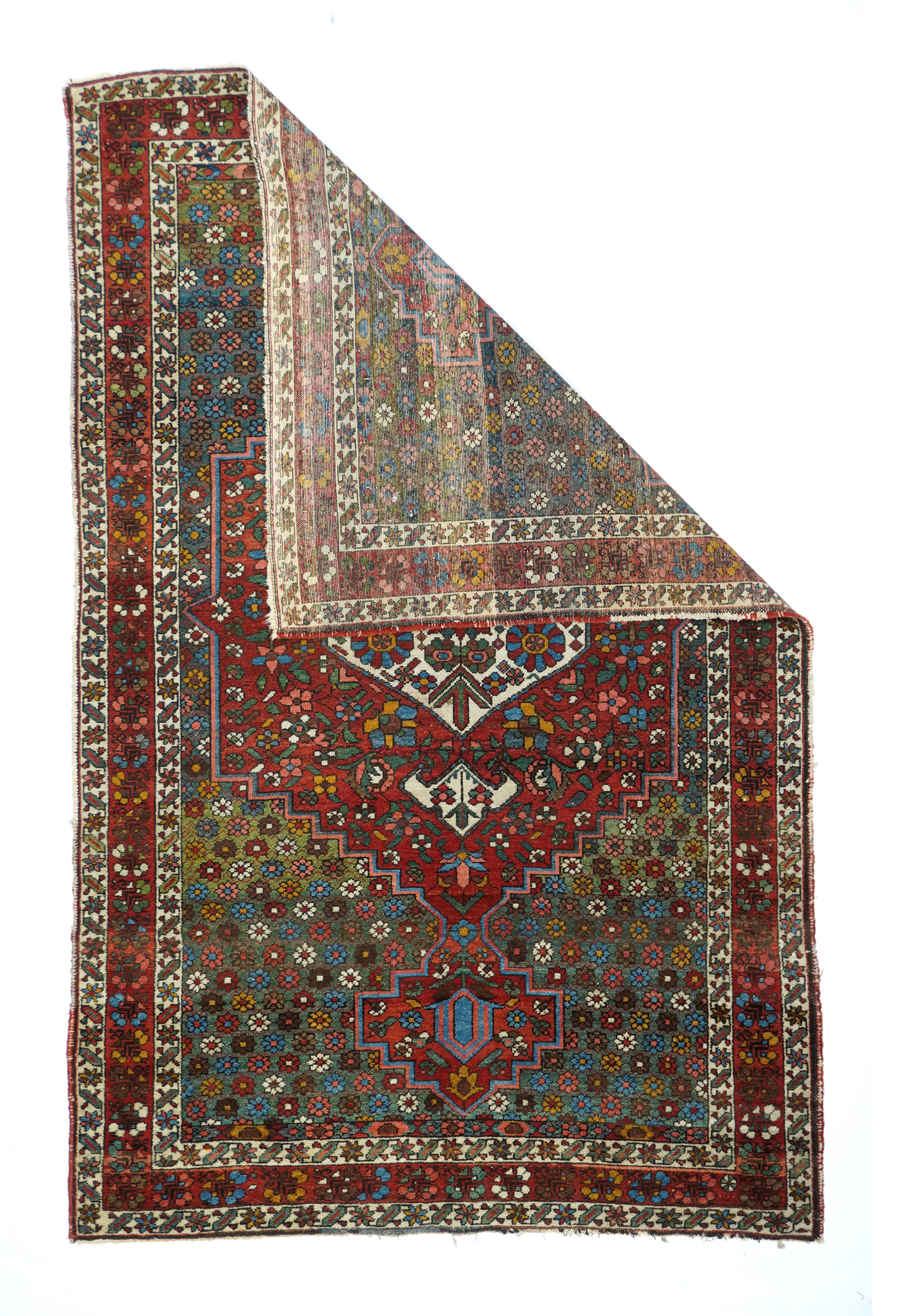 Vintage Tabriz rug, measures : 9'9'' x 13'9''. The delightfully abrashed green field is filled with randomly colored small rosettes, and hosts a red stepped medallion with gigantic tonally en suite pendants and an eggshell sub-medallion with its own