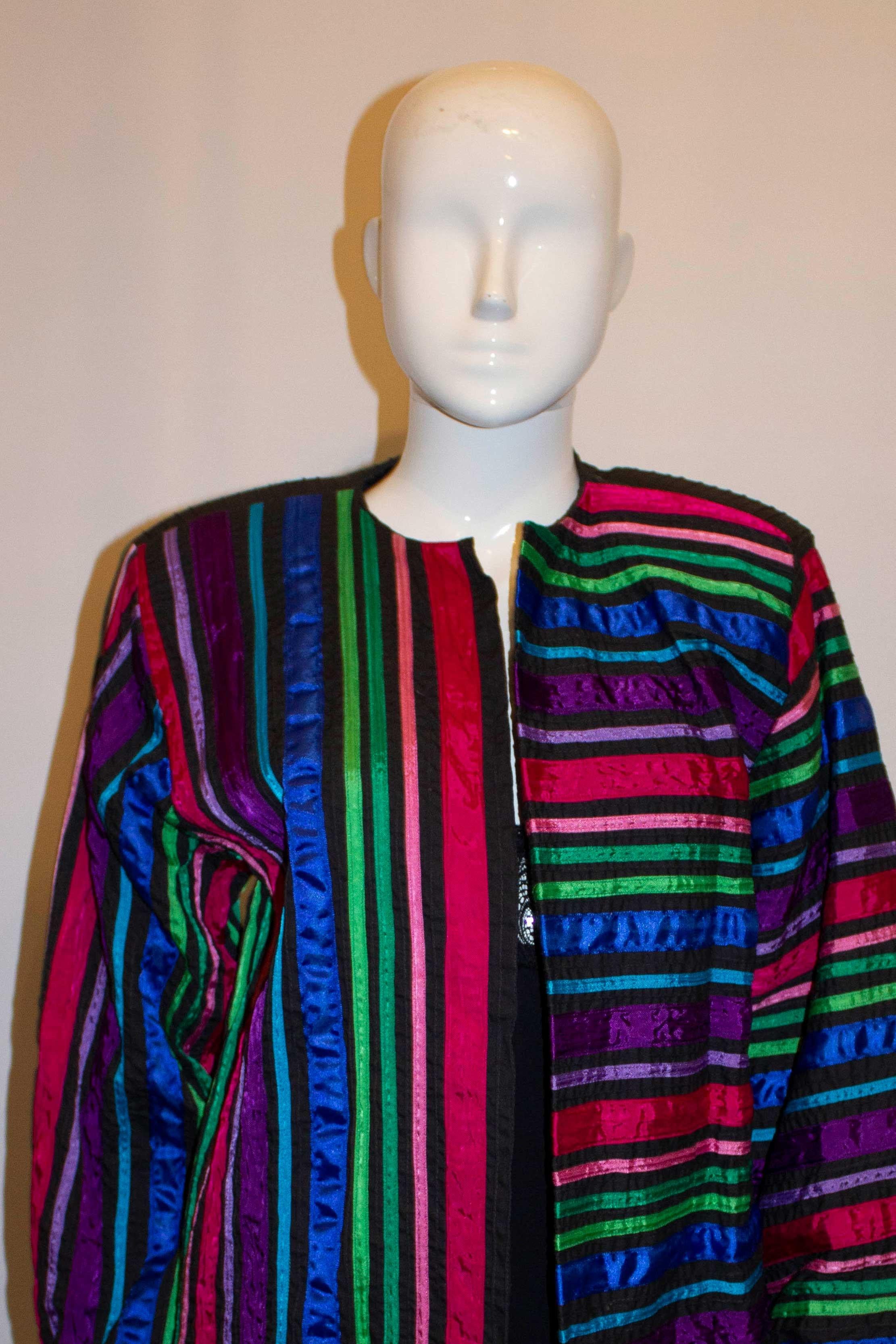 A colourful vintage jacket by Tachi Castillo, Mexico.  The jacket ahs a round neck, with a pocket on either side. It is fully lined and has multi colour ribbon decoration, horizontal and vertical.  - a colour to go with everything. 
Marked size M,
