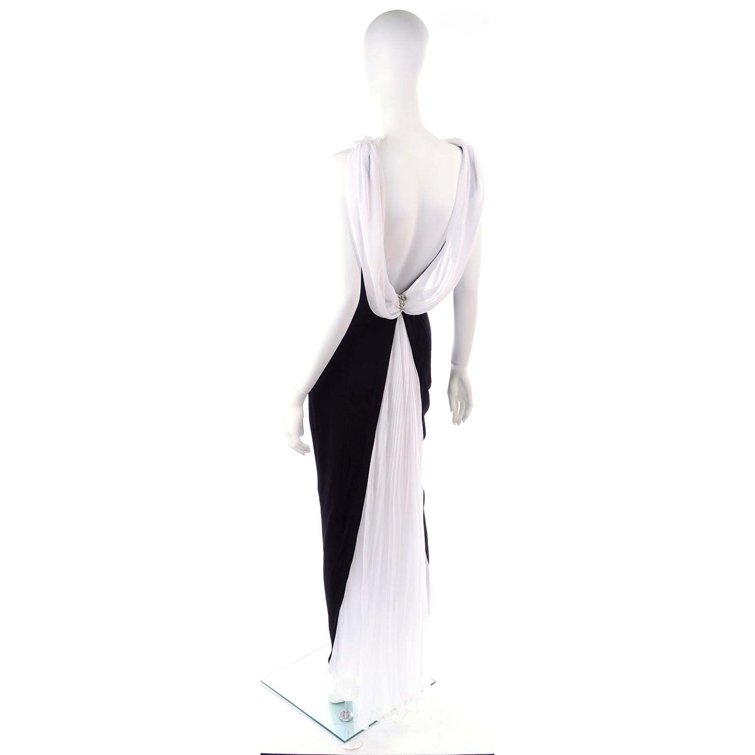 This is a lovely vintage black evening gown by Tadashi Shoji with a dramatic, deep, low open back and beautiful white chiffon pleated drape that goes to the floor like a train. This dress was made in the USA in the 1990's and we estimate it to fit a